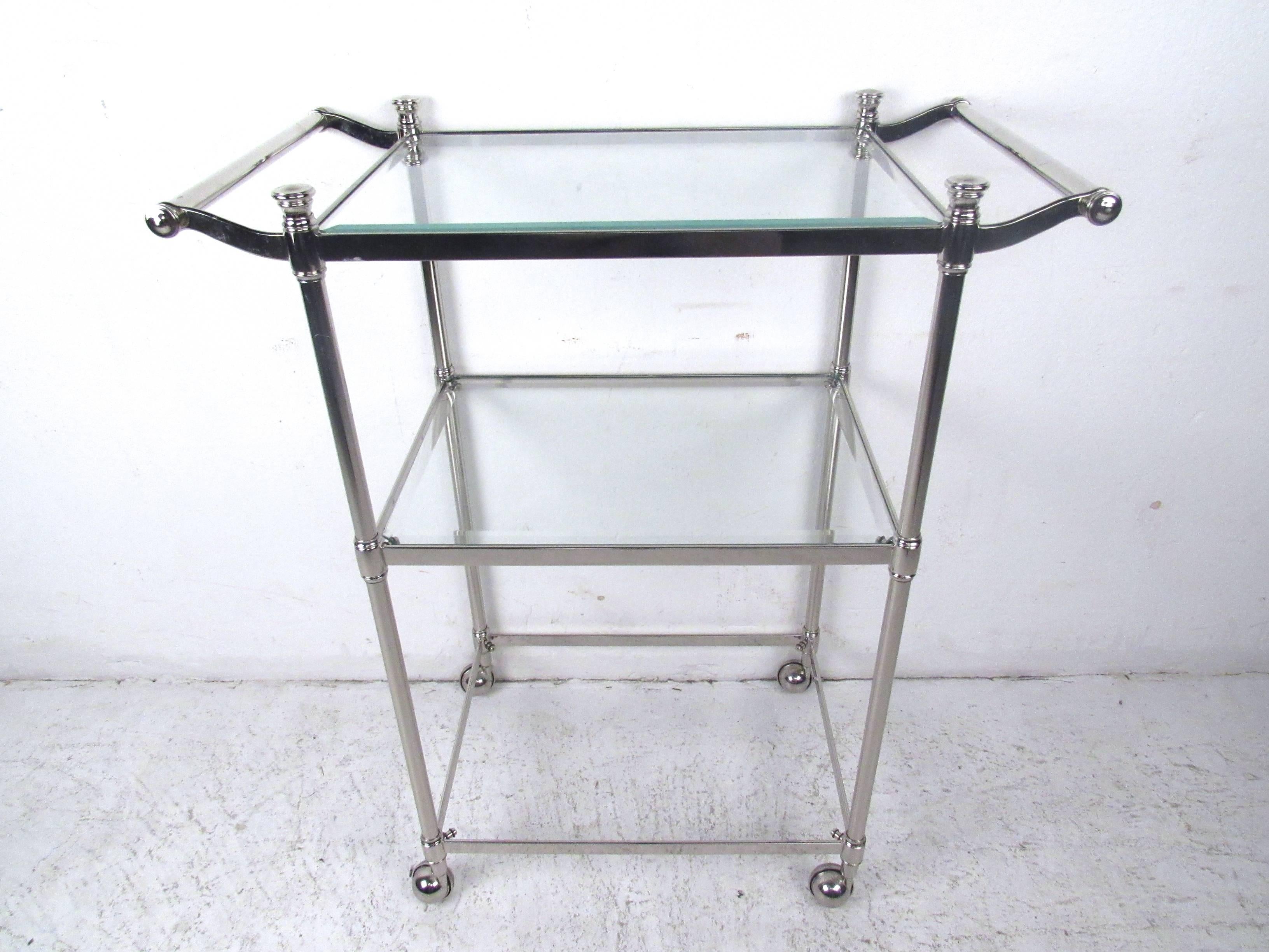 This stylish vintage rolling cart features heavy chrome construction with multiple shelves for storage and serving. Unique detailed trim, casters and double-sided handles make for easy use. Please confirm item location (NY or NJ).