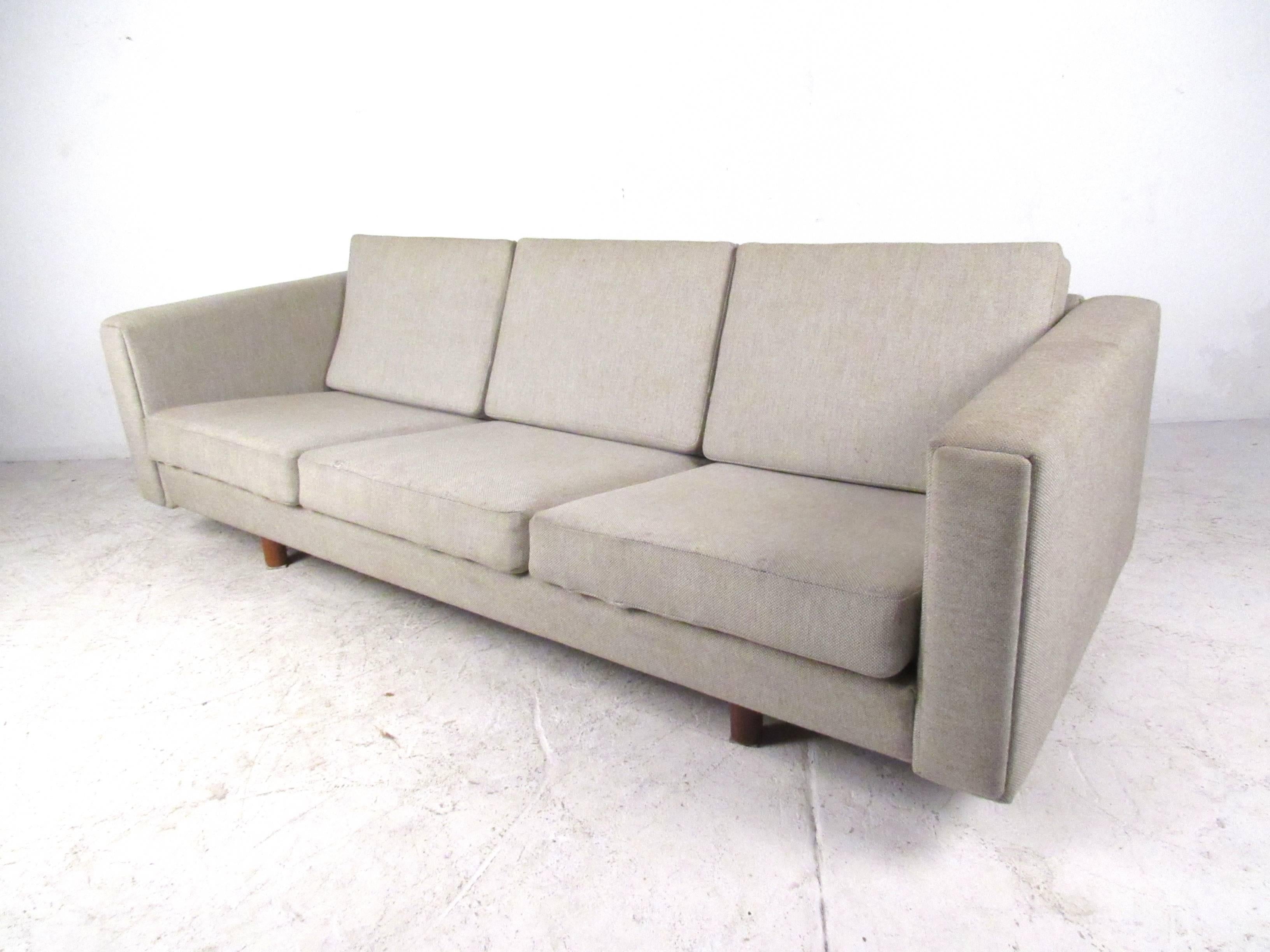This beautiful matching pair includes three-seat sofa and two person loveseat, both featuring the unique lines and comfortable proportions of Hans Wegner's Mid-Century style. Please confirm item location (NY or NJ). Loveseat dimensions: 56.25 W 31.5