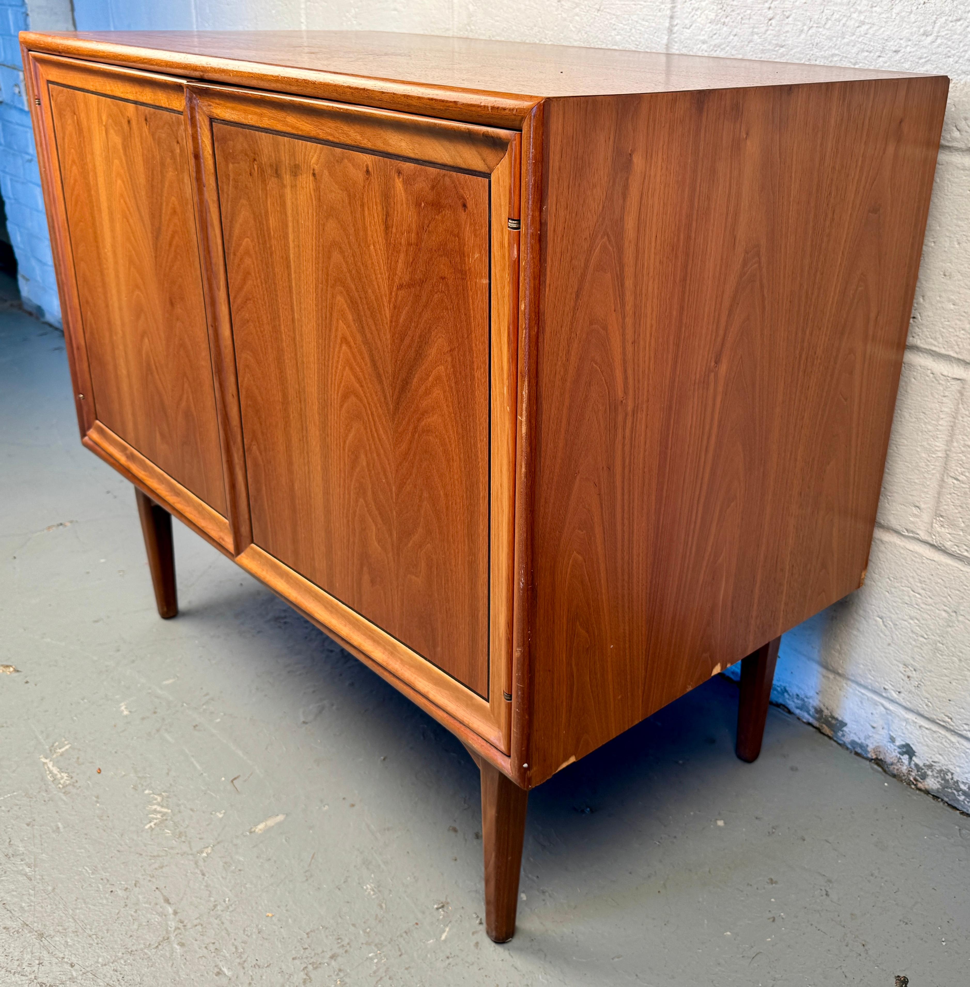 Celebrate the golden age of American design with this Drexel Declaration walnut record cabinet, a rare and beautifully crafted piece from the iconic Declaration collection designed by Kipp Stewart and Stewart MacDougall in the early 1960s.

Please