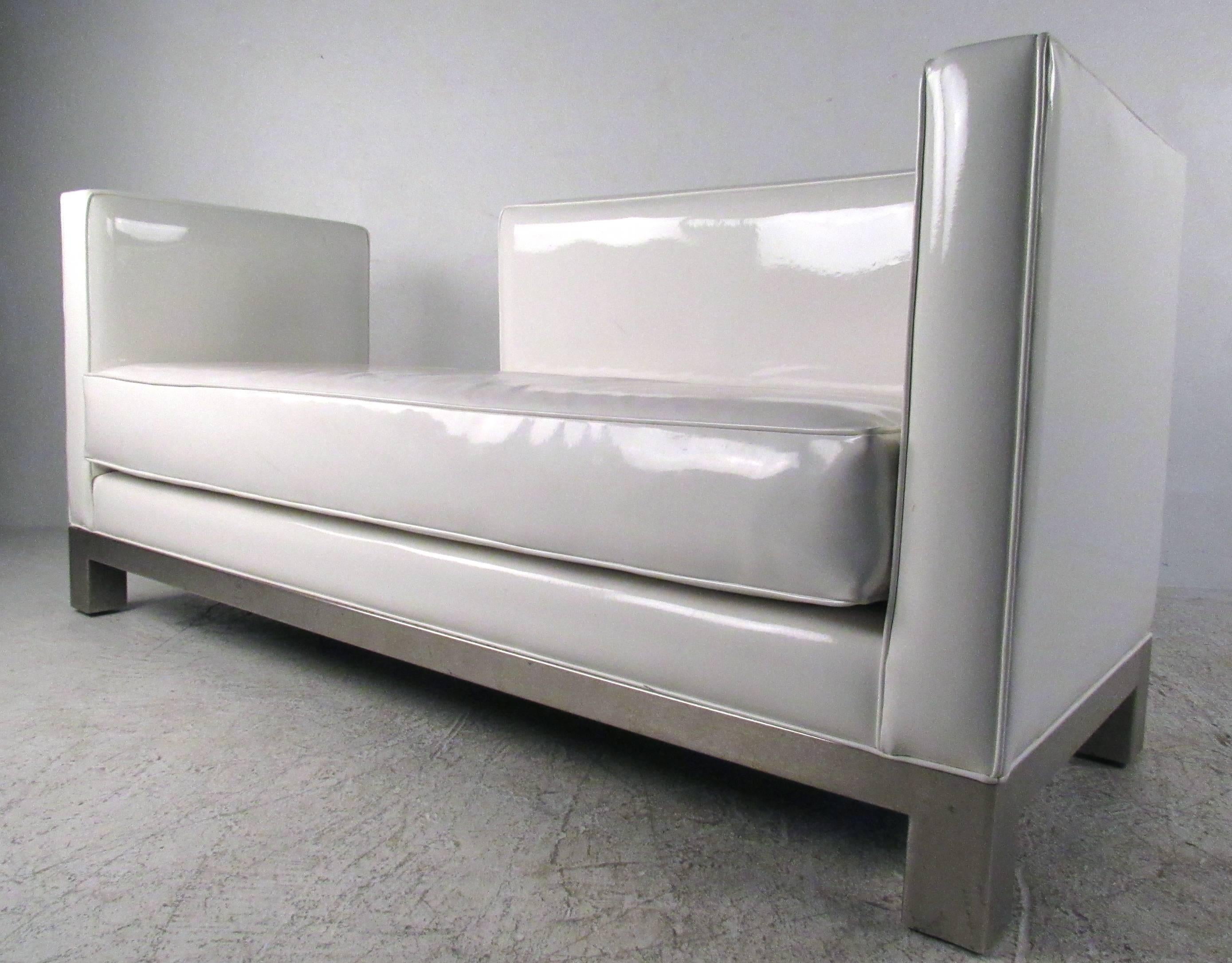 This modern white vinyl lounge makes a comfortable and unique seating addition in home, office, or lobby. Unique sectional style allows for use in a variety of seating arrangements. Brushed metal base paired with vinyl and straight lines add to the