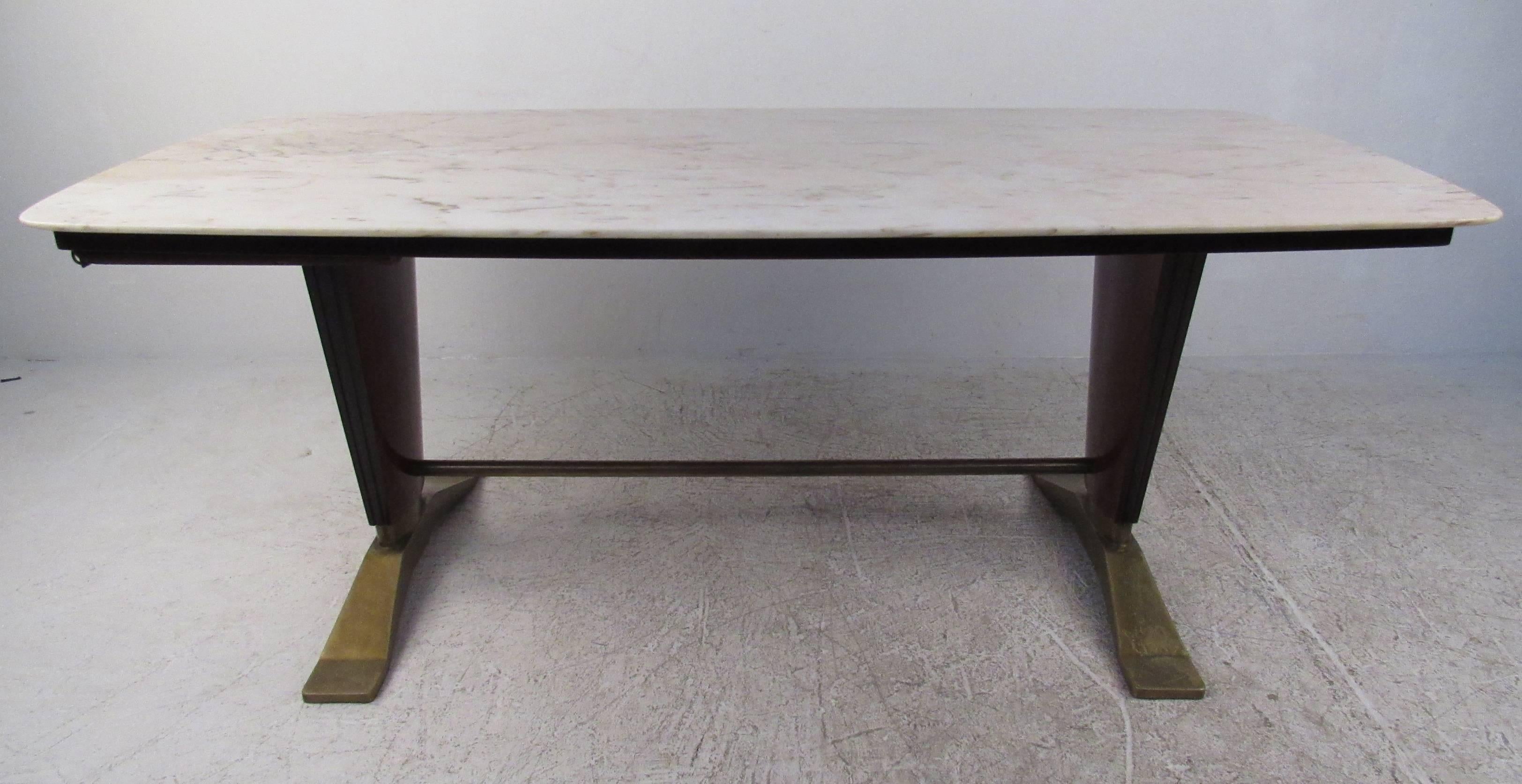 This elegant Italian marble-top dining table supported by teak ebonized legs with brass base and stretcher.  Stylish mid-century dining table for any luxury dining room. Please confirm item location (NY or NJ) with dealer.
              