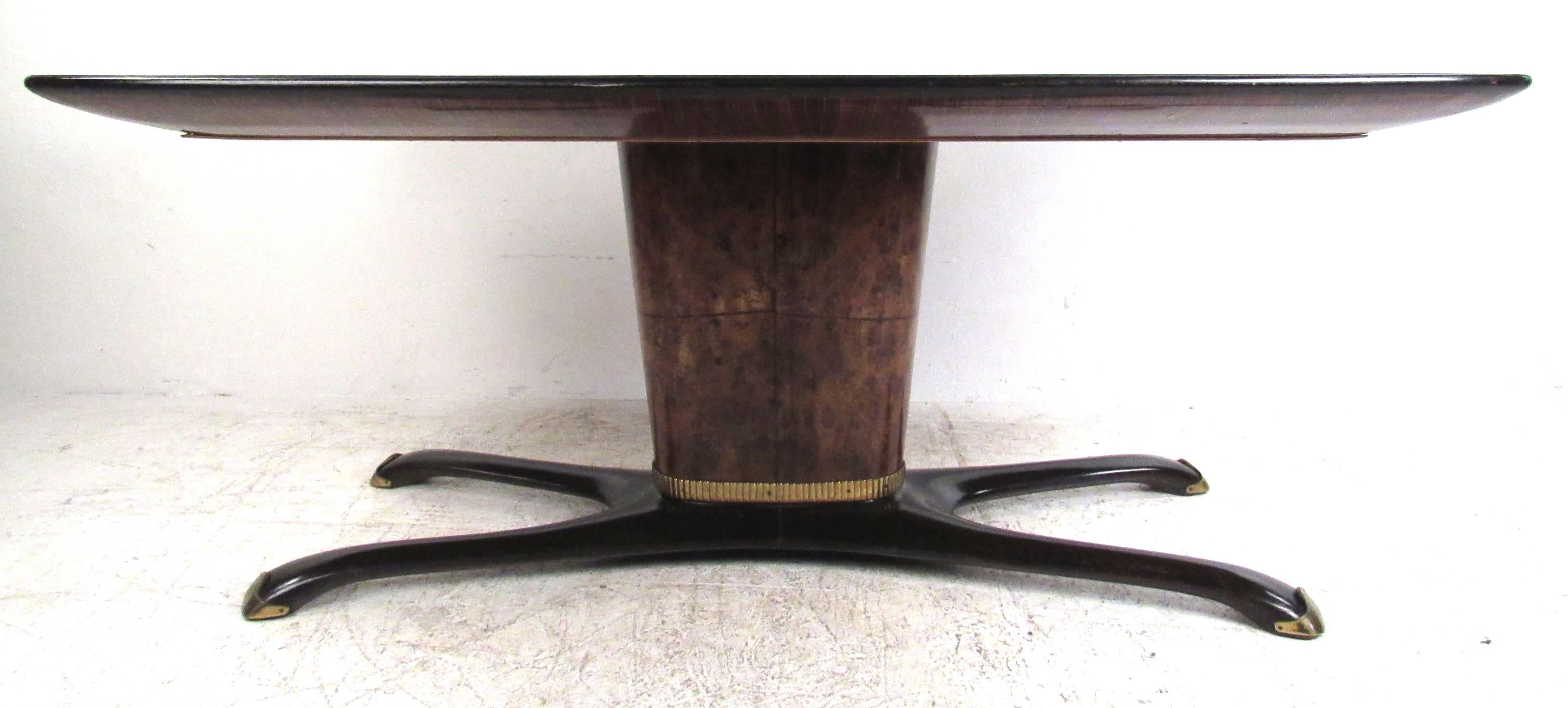 Elegant Italian green glass dining table with black ebonized legs, brass accents burl wood base. Please confirm item location (NY or NJ) with dealer.