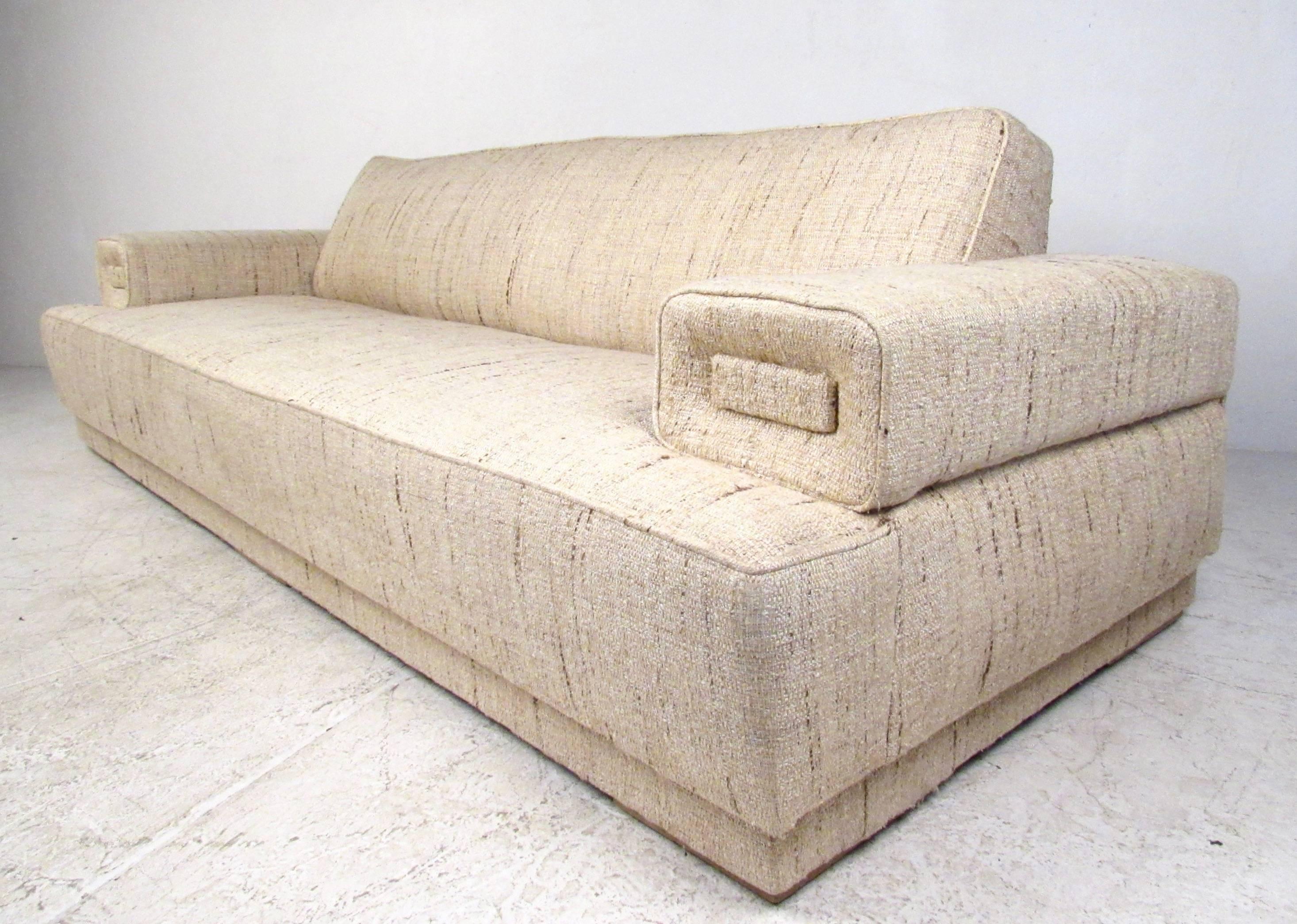 This stunning vintage sofa features intact original fabric and a unique sculpted single seat design. This visually impressive Mid-Century sofa is incredibly comfortable while maintaining it's elegant Mid-Century appeal. Please confirm item location