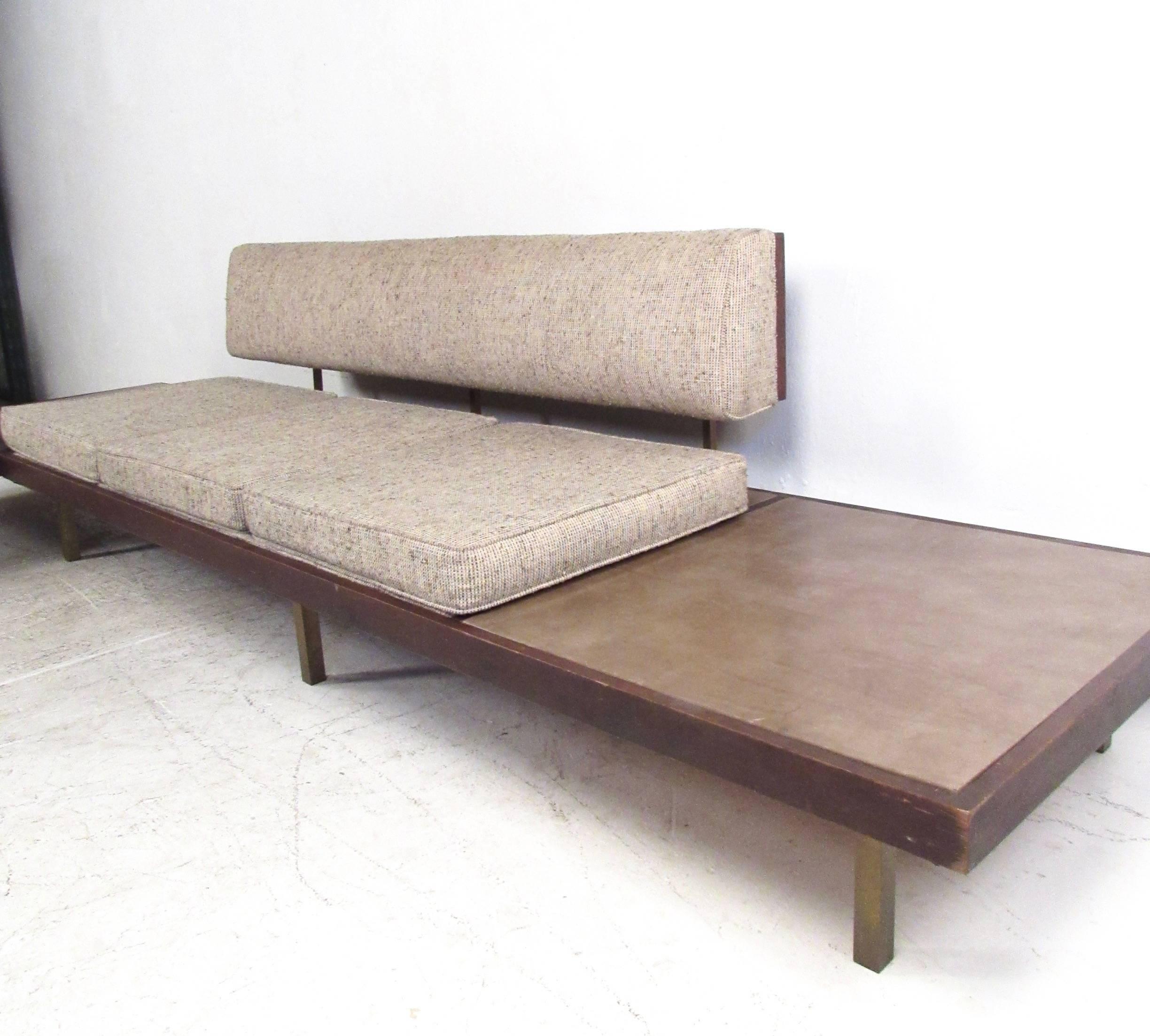 This unique matching pair of vintage sofa's features two and three-seat design, both with Naugahyde covered end tables. Unique cane and brass seat backs accentuate the vintage fabric while adding to the Classic Mid-Century style of the pair.