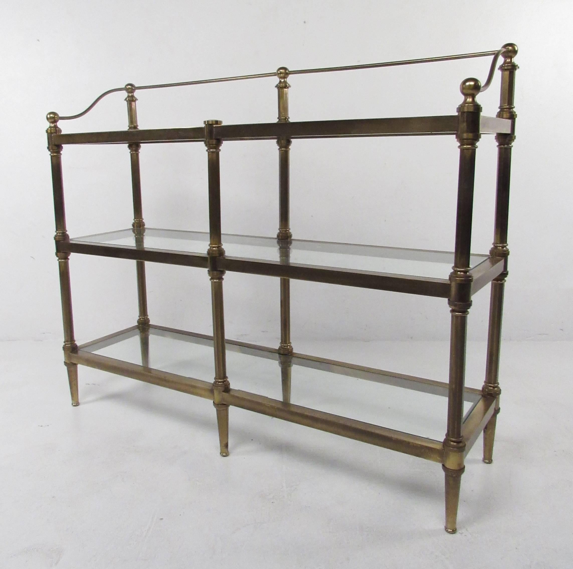Regency style low brass display etagere with glass shelves. Please confirm item location (NY or NJ) with dealer.