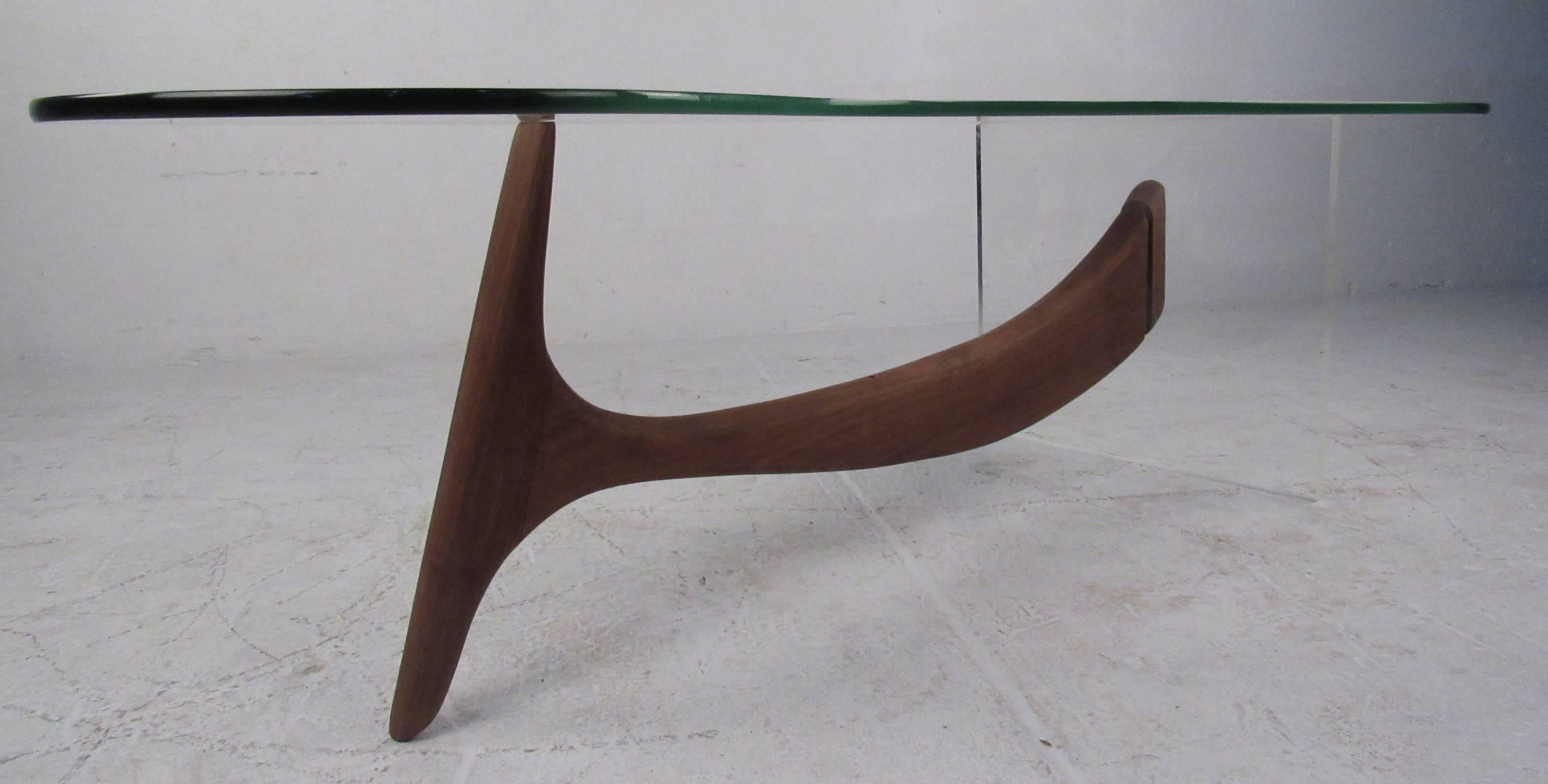 Sculptural cocktail table featuring a kidney shaped glass top and a walnut and Lucite base. Please confirm item location (NY or NJ) with dealer.
 
