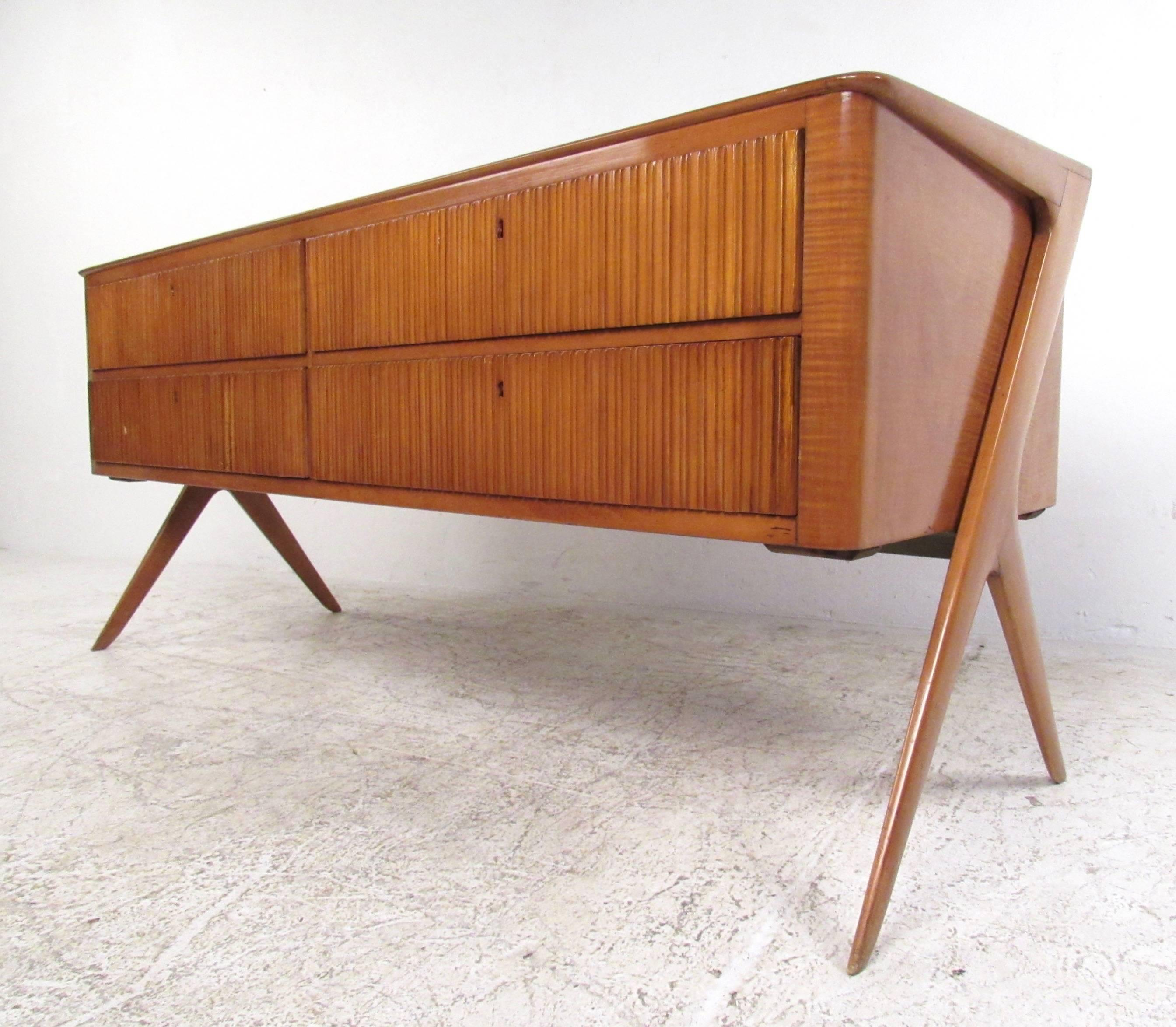 This stunning vintage sideboard features four locking drawers, stylish sculpted legs and a unique glass top. Decorative details in the sculpted design of this elegant piece set the Mid-Century Italian server apart from it's peers. Please confirm