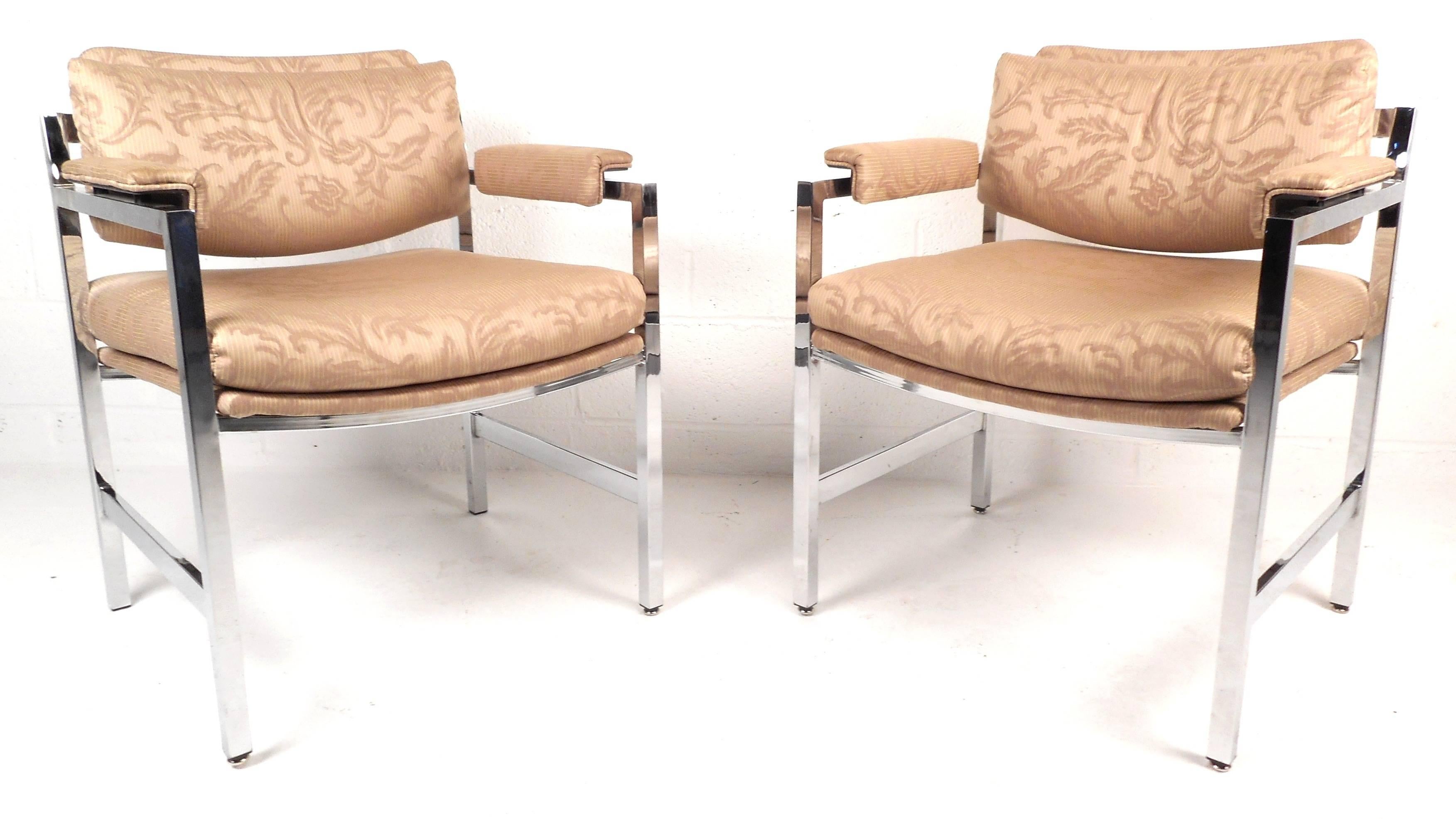 This elegant pair of vintage modern chrome frame arm chairs feature comfortable upholstered armrests with unique designs on the fabric. The thick padded seat and back rest ensure maximum comfort in any seating arrangement. The heavy chrome frame