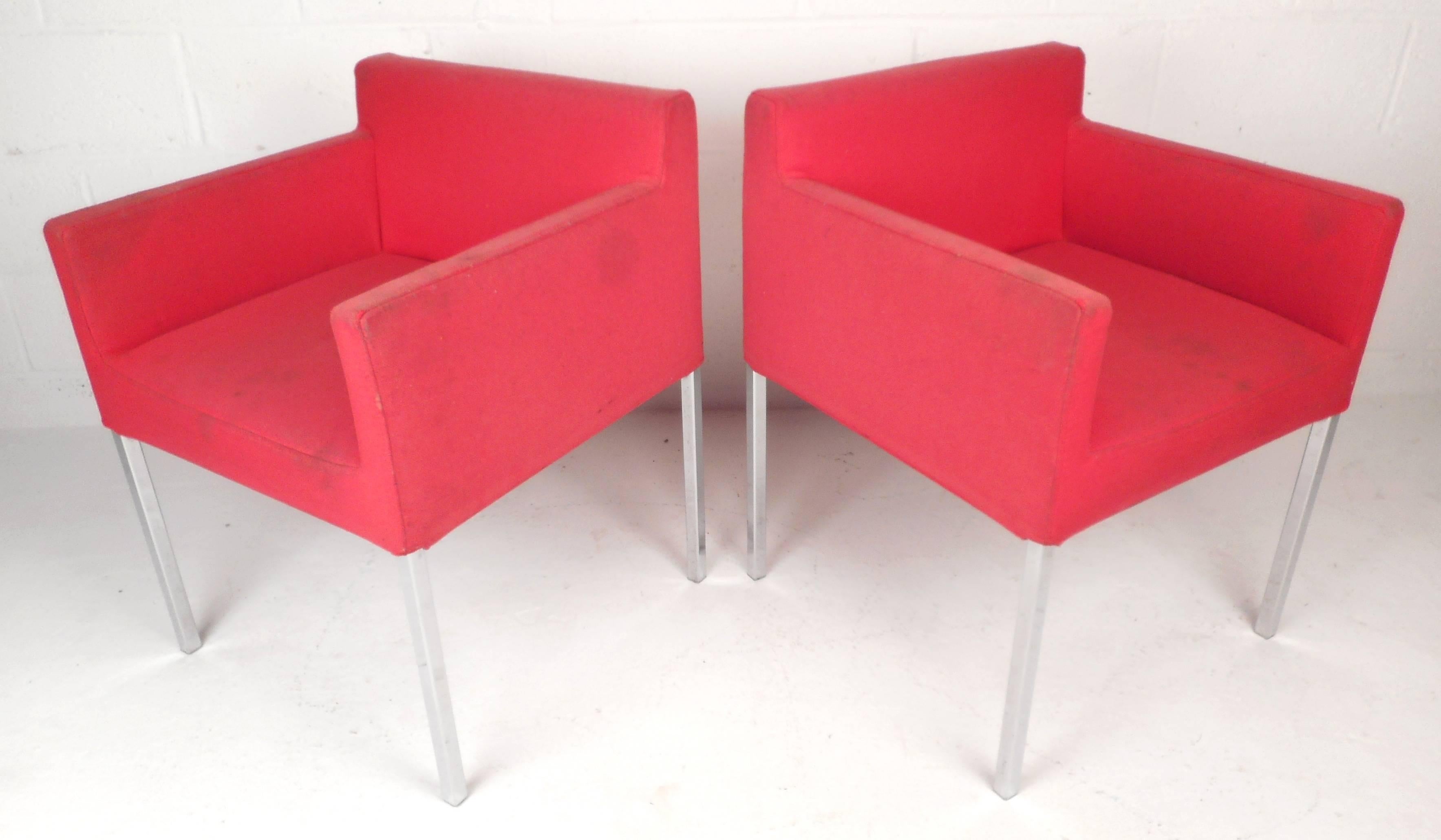 This lovely pair of Mid-Century Modern club chairs feature comfortable vintage upholstery and a handle in the back for convenience. The thick chrome legs and modern design make them the perfect addition to any setting. Please confirm item location