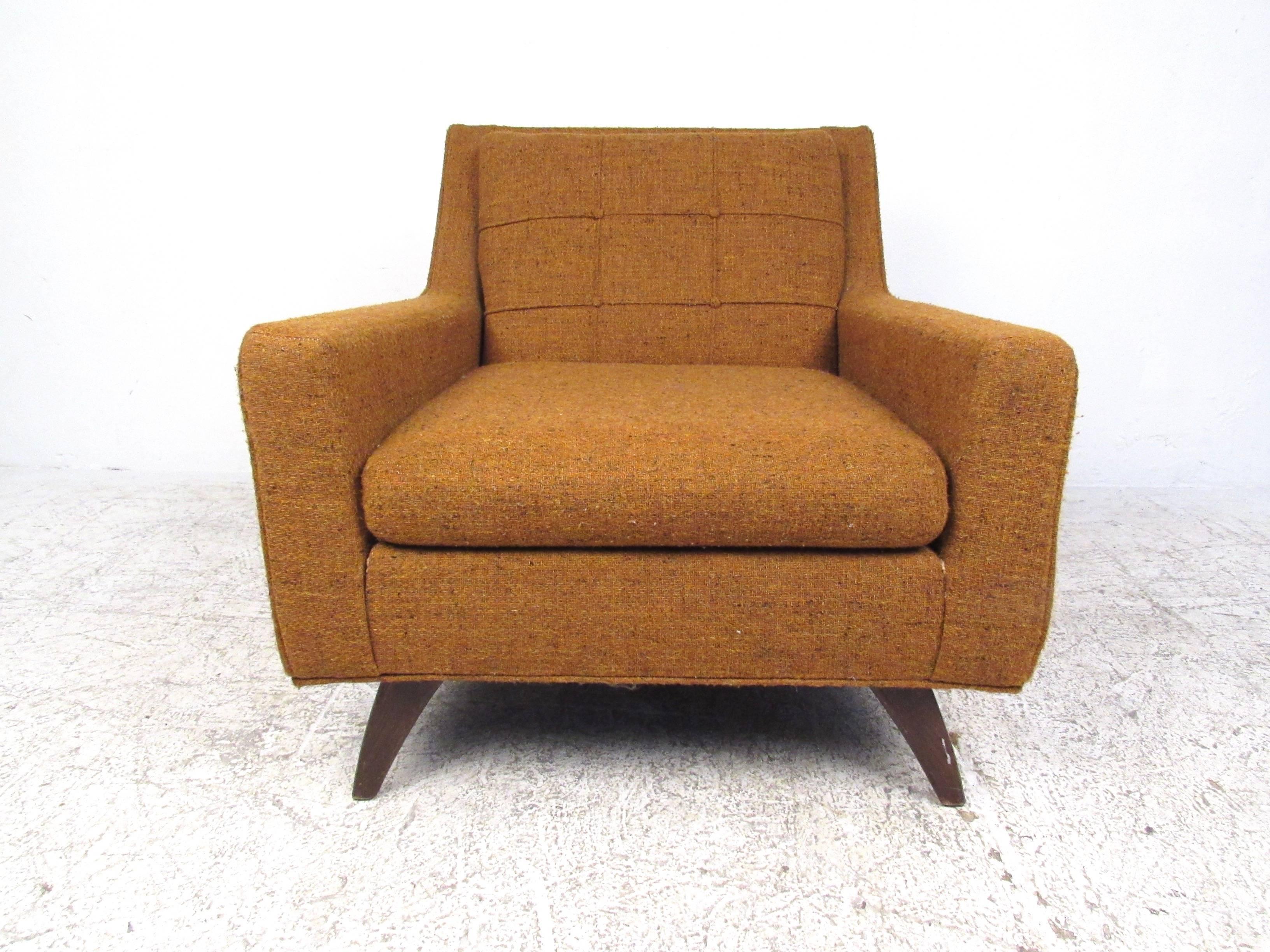 This Mid-Century lounge chair makes a comfortable and stylish addition to any interior, combining vintage fabric with shapely seat design. Unique tapered legs in the style of Adrian Pearsall add to the charm of the chair, please confirm item