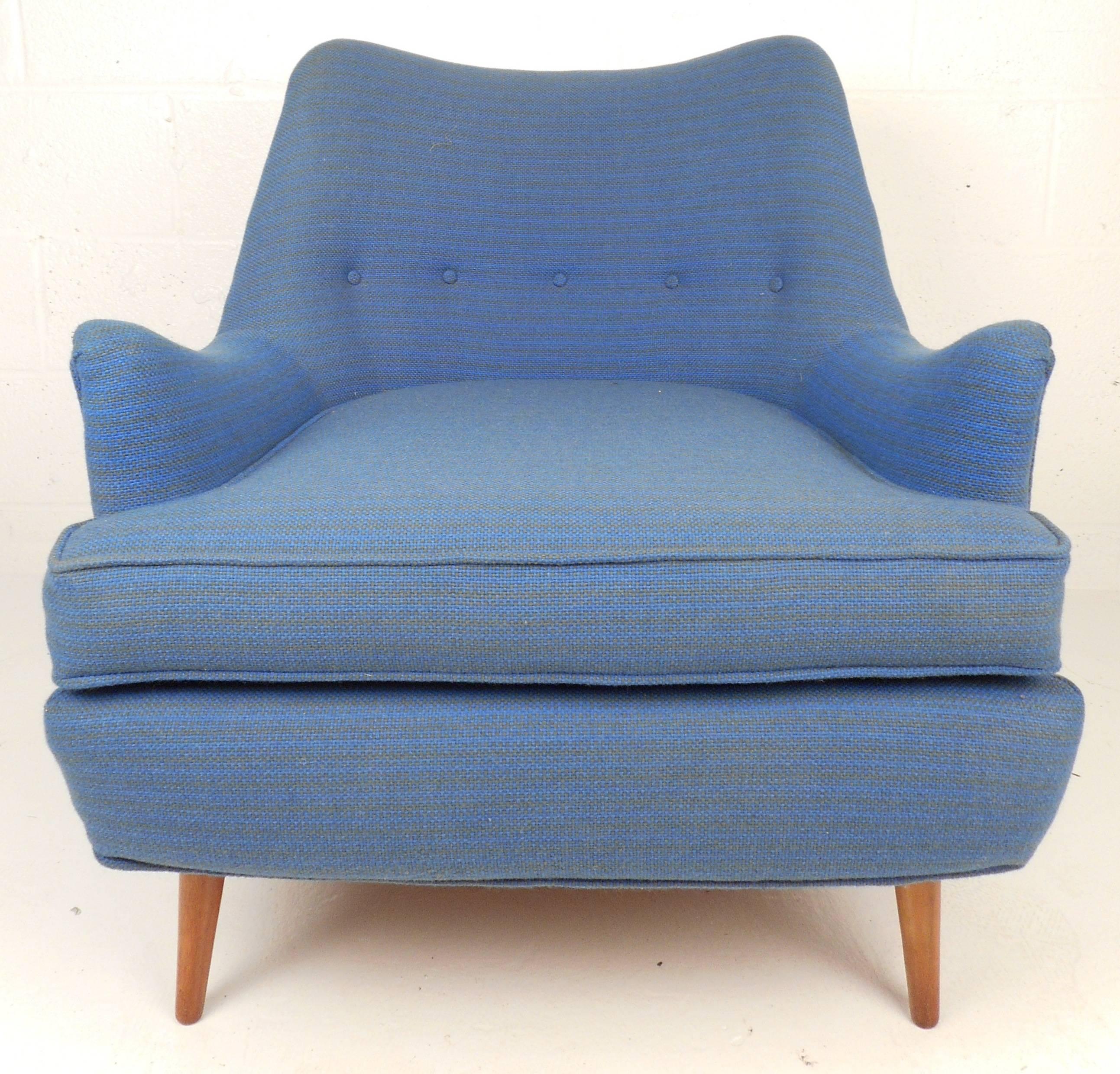 Stunning Mid-Century Modern lounge chair with sculpted armrests, tufted seat back and tapered legs. The stylish and comfortable baby blue armchair features shapely design that makes the perfect complement to any interior. Please confirm item