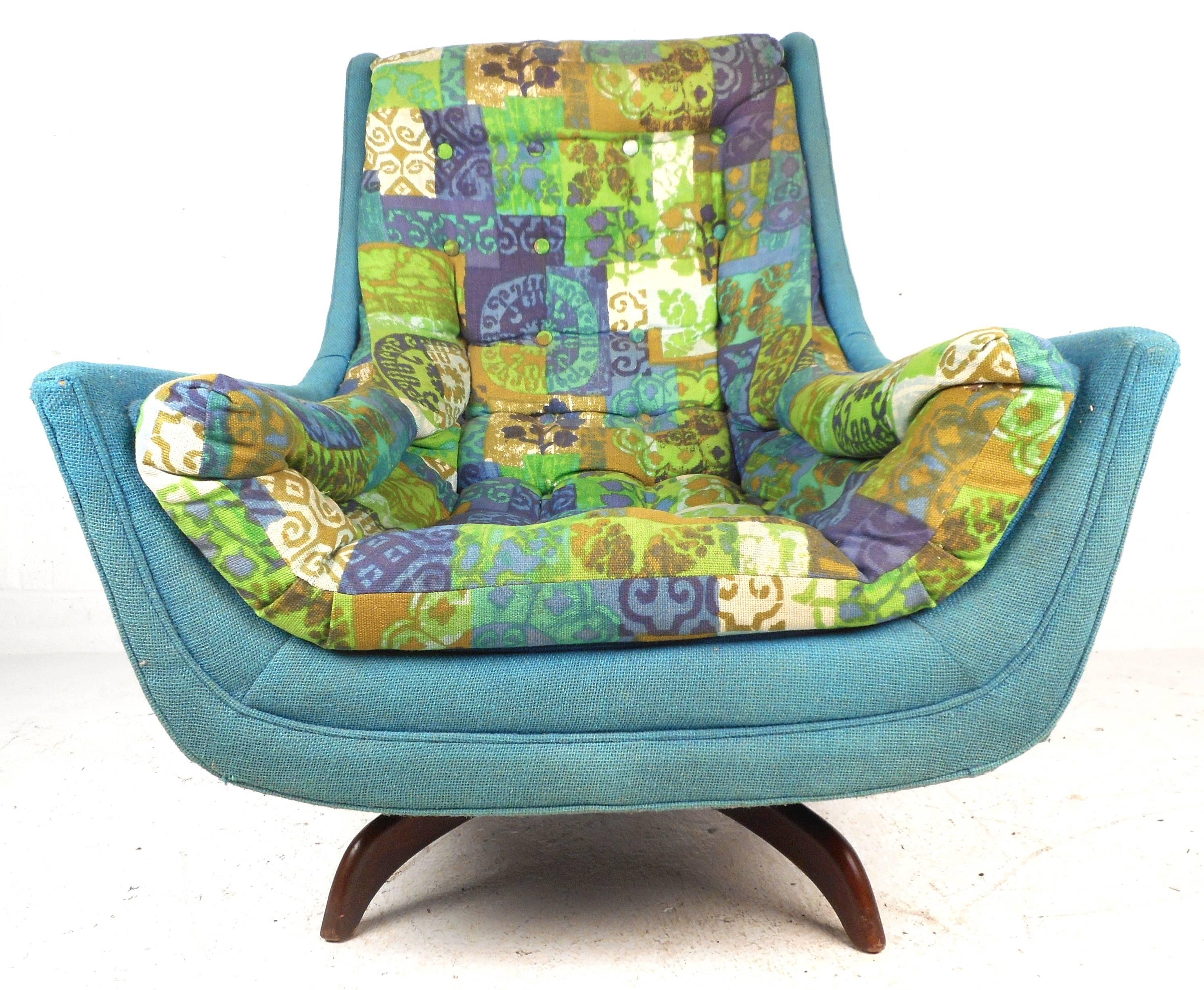This versatile lounge chair functions as a swivel chair or a rocking chair ensuring optimal comfort. The colorful and soft upholstery is sure to make an impression in any modern interior. The unique chair sits on top of sculpted walnut legs adding
