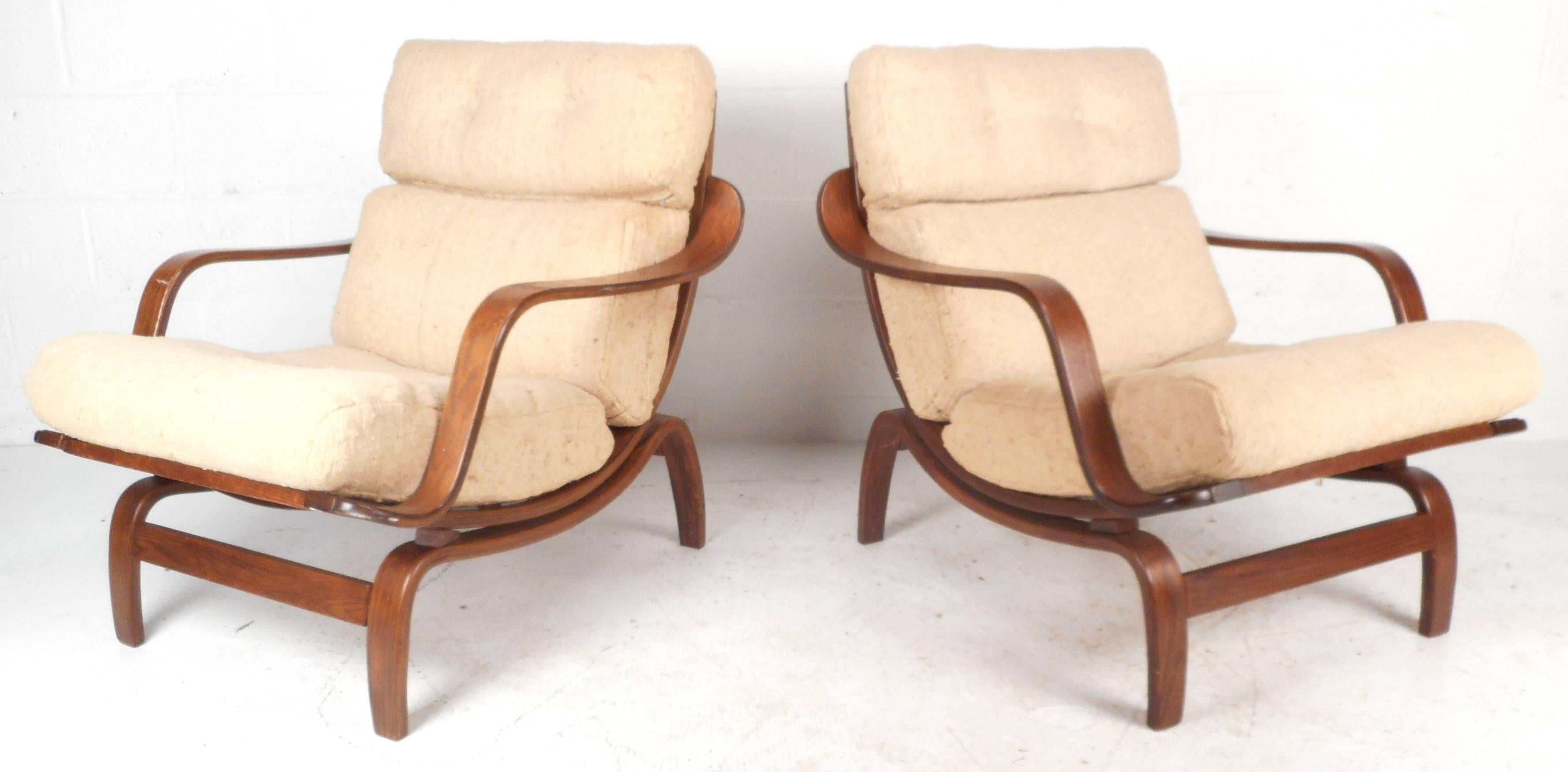 Pair of stylish sculpted bentwood lounge chairs with plush cream colored upholstery. Unique sculpted bentwood design features vintage walnut finish and tufted head rests add to their incredible comfort. Please confirm item location (NY or NJ).