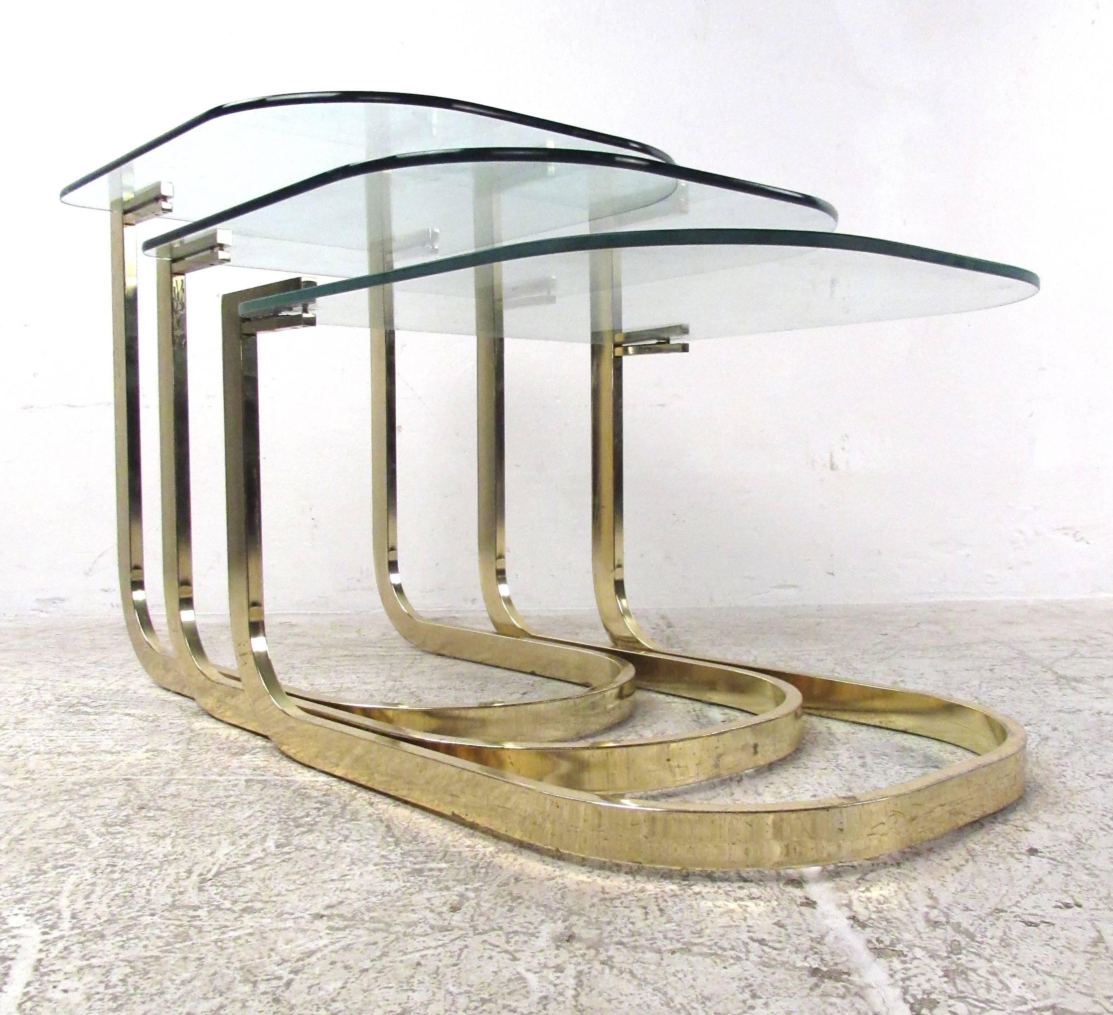Set of three-flat bar nesting tables with glass tops by Design Institute America. A unique cantilever design that is sure to add style and grace to any modern interior. Please confirm item location (NY or NJ) with dealer.

H 22.25 in. x W 20 in. x D