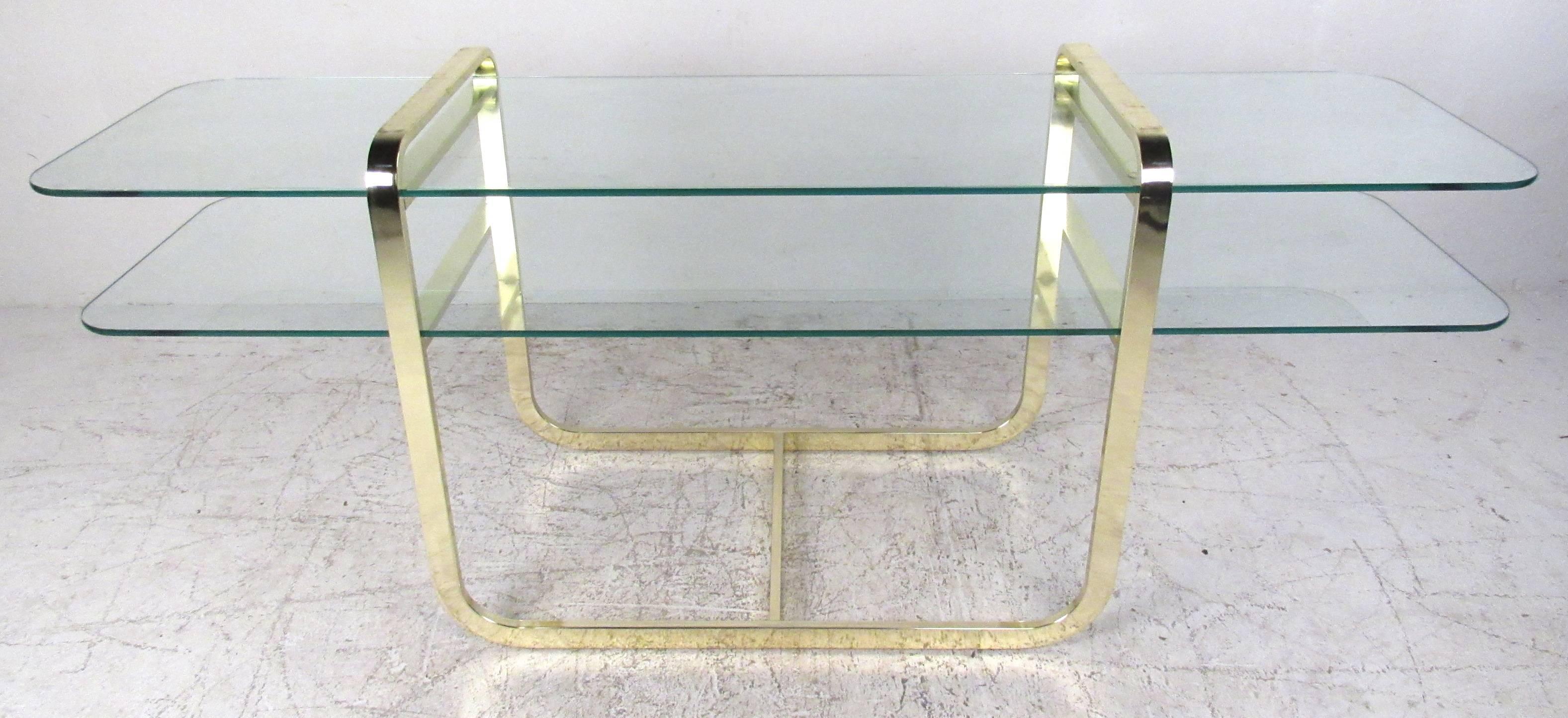 Two-tier flat bar brass and glass console/hall table in the manner of Milo Baughman. Please confirm item location (NY or NJ) with dealer.