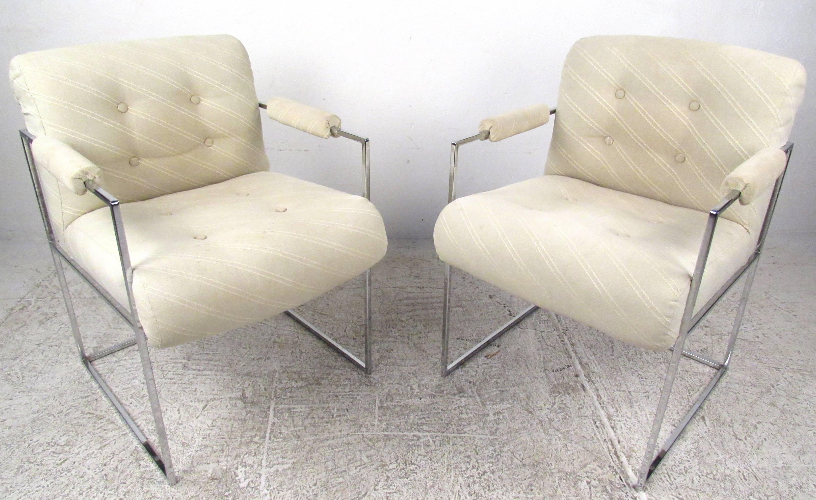 Classic pair of chrome frame dining/lounge chairs by Milo Baughman for Thayer Coggin. This attractive pair boasts thick padded seating covered in plush tufted upholstery. A unique thin chrome frame with cubed sides and upholstered arm rests ensures