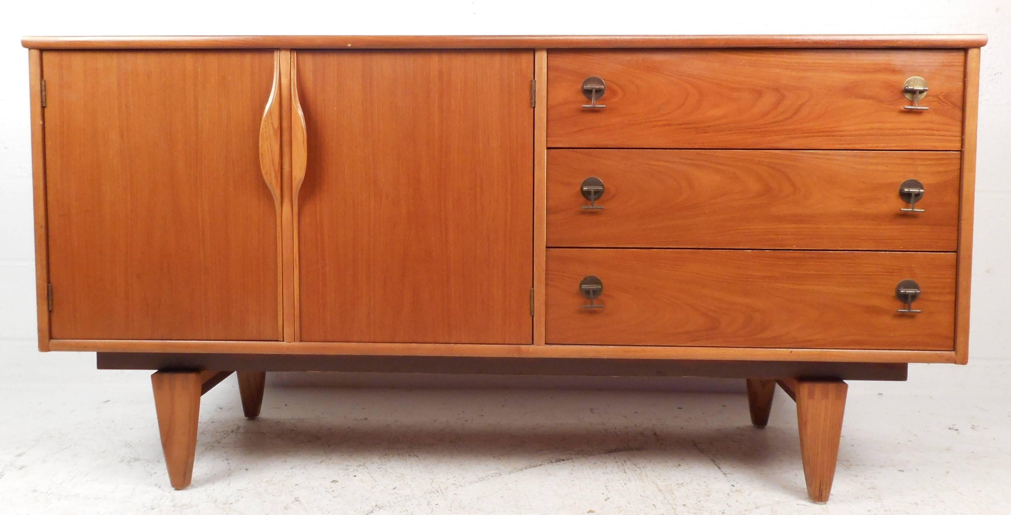 This beautiful modern credenza is stamped 
