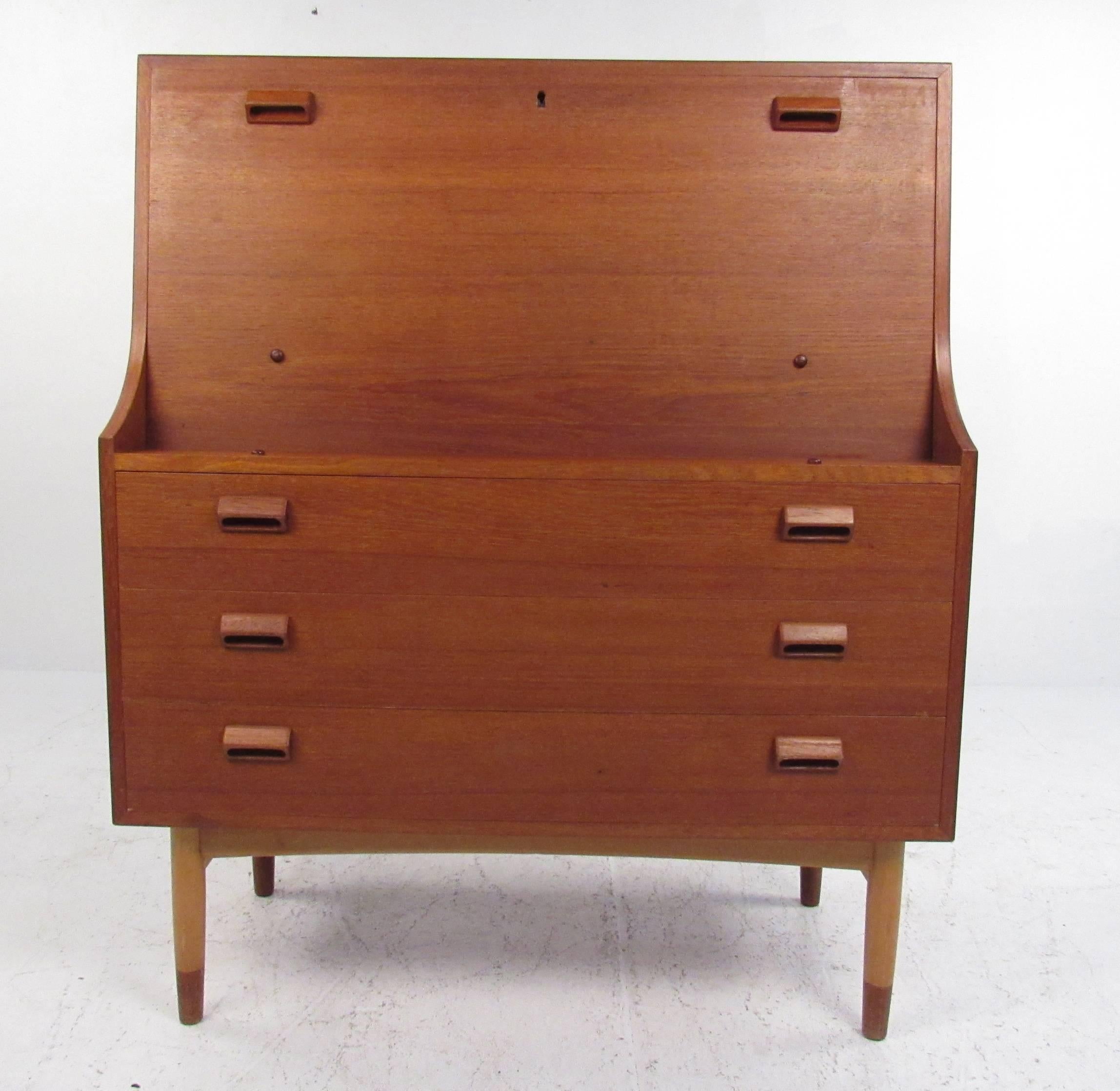 Nicely designed, compact drop front secretary with three drawers below and storage or cubby holes as well as a writing surface on top. Please confirm item location (NY or NJ) with dealer.