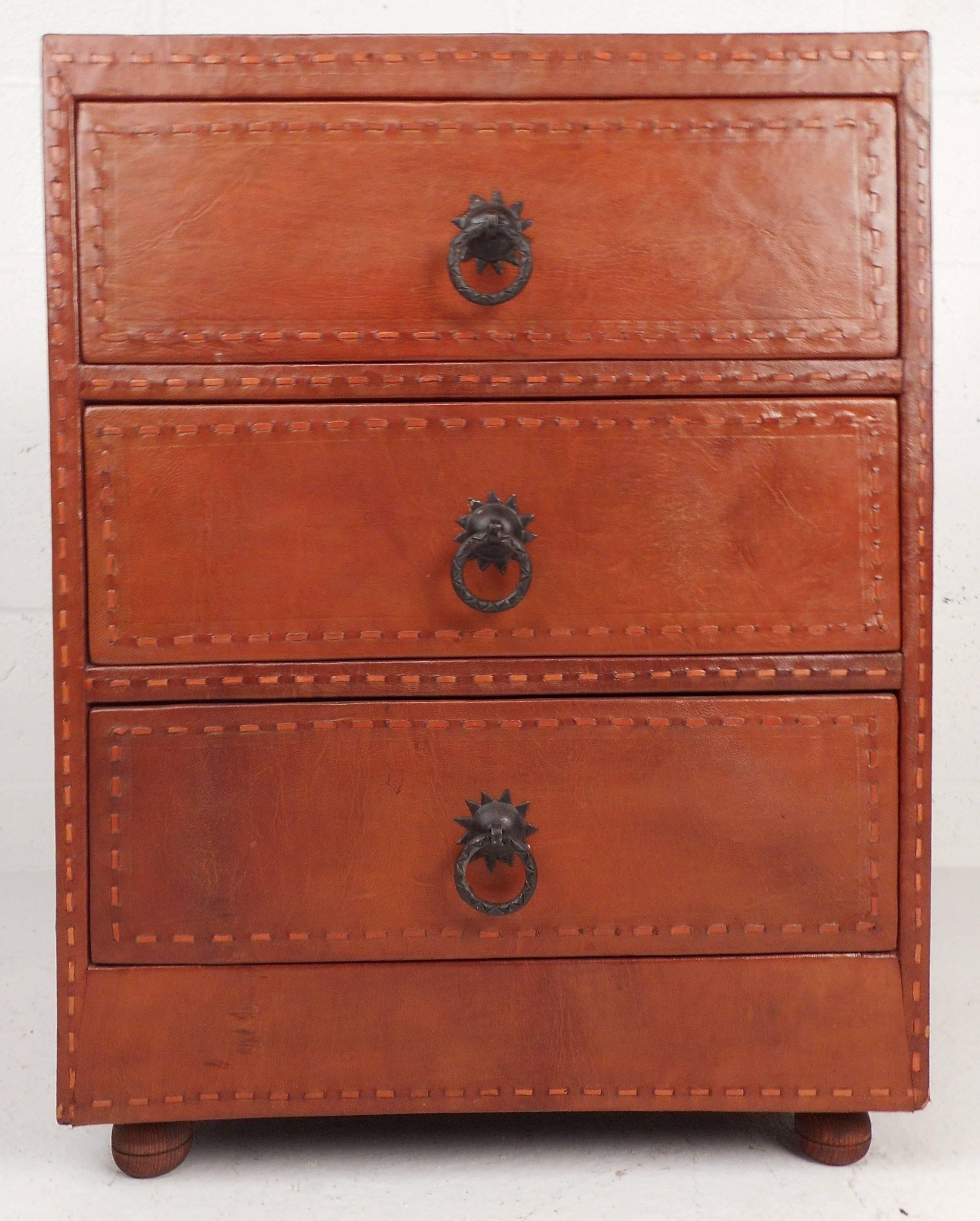Handsome European style three-drawer chest or nightstand features Spanish cordovan leather and unique metal pulls. The beautiful pyrrole orange leather features unique stitched trim with charcoal black interior, makes a great nightstand or lamp
