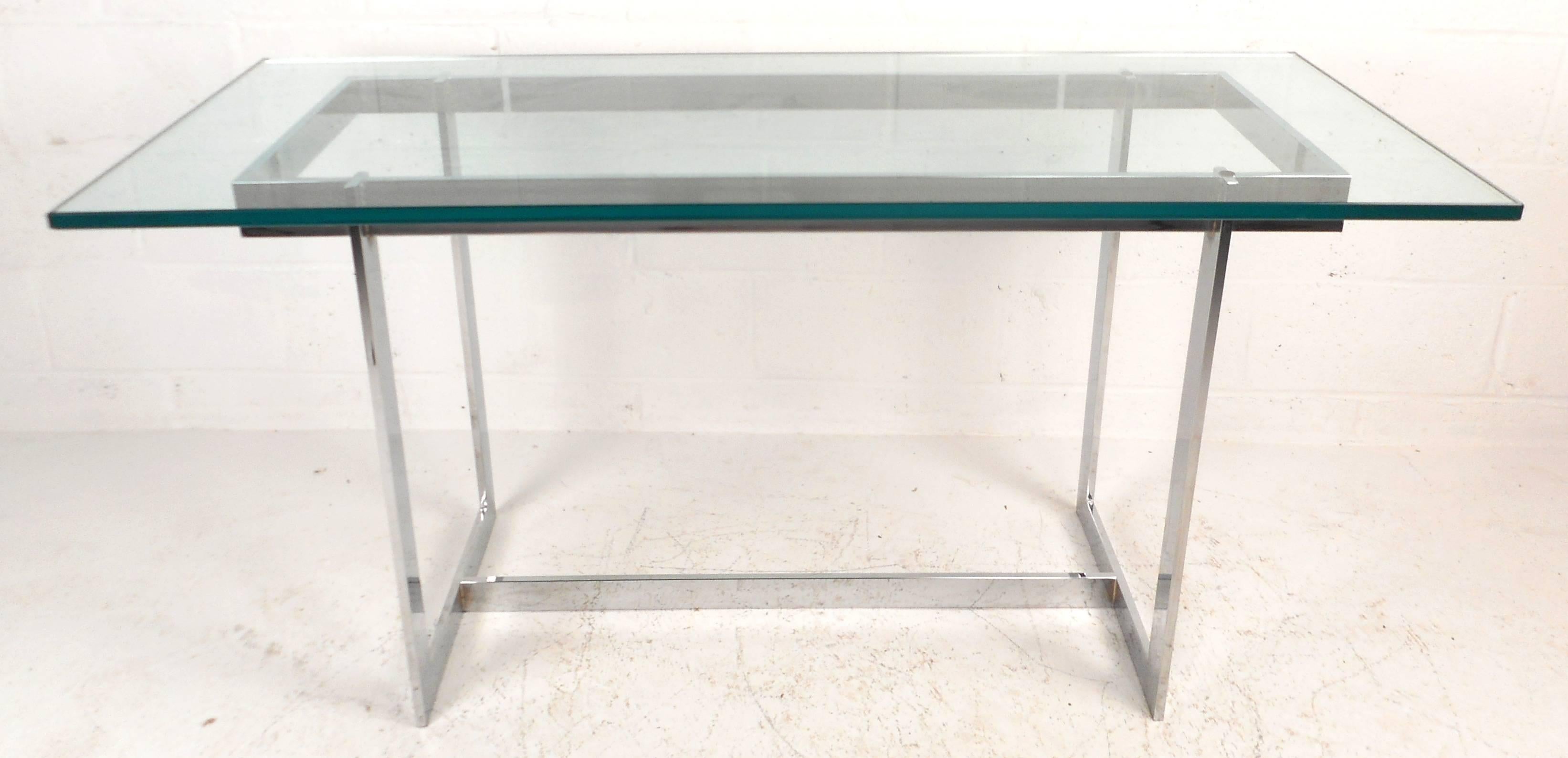 Stunning vintage modern console table features a heavy sculpted chrome frame and a 1