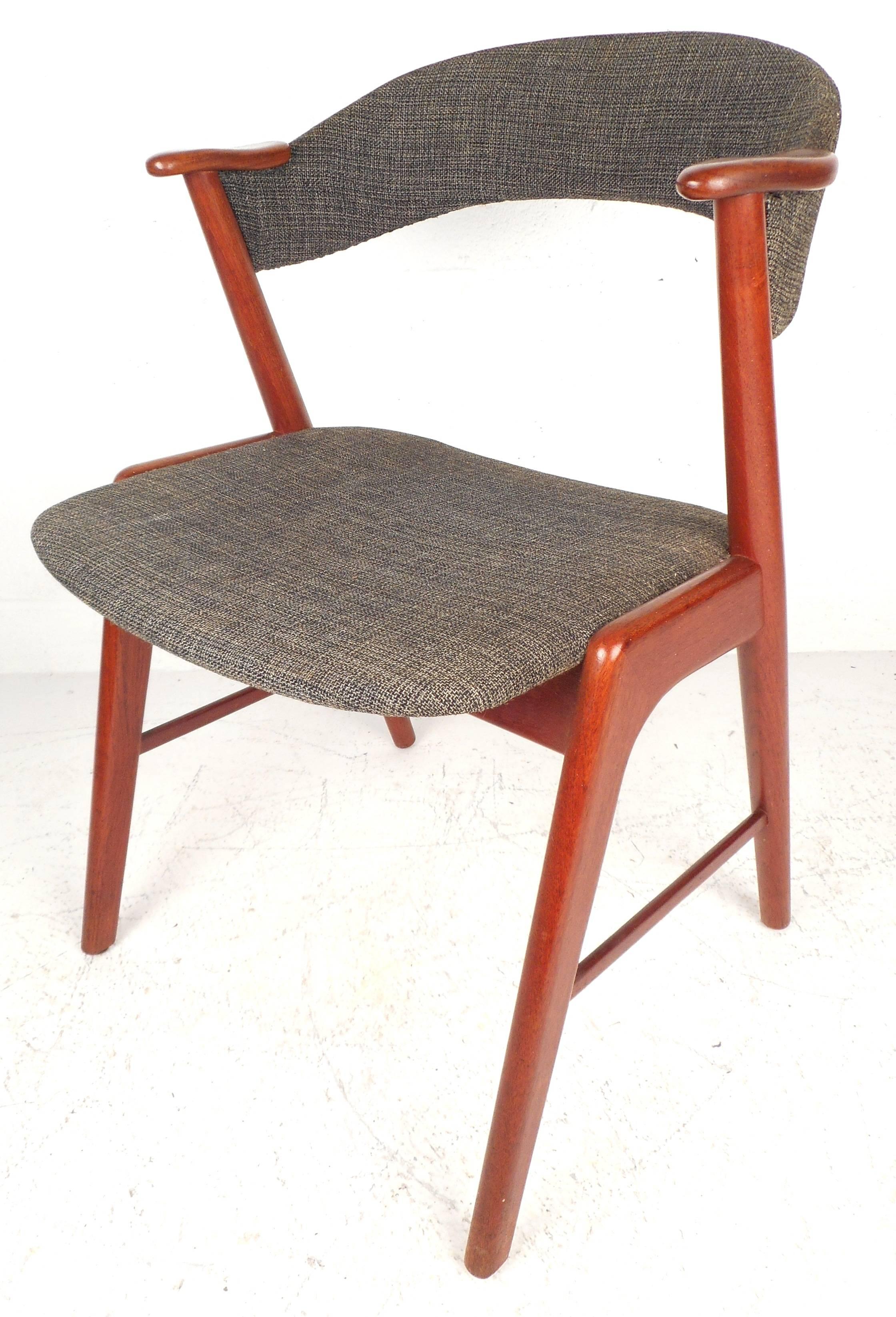 Stunning set of four Mid-Century dining chairs feature comfortable barrel back rests and unique angled 