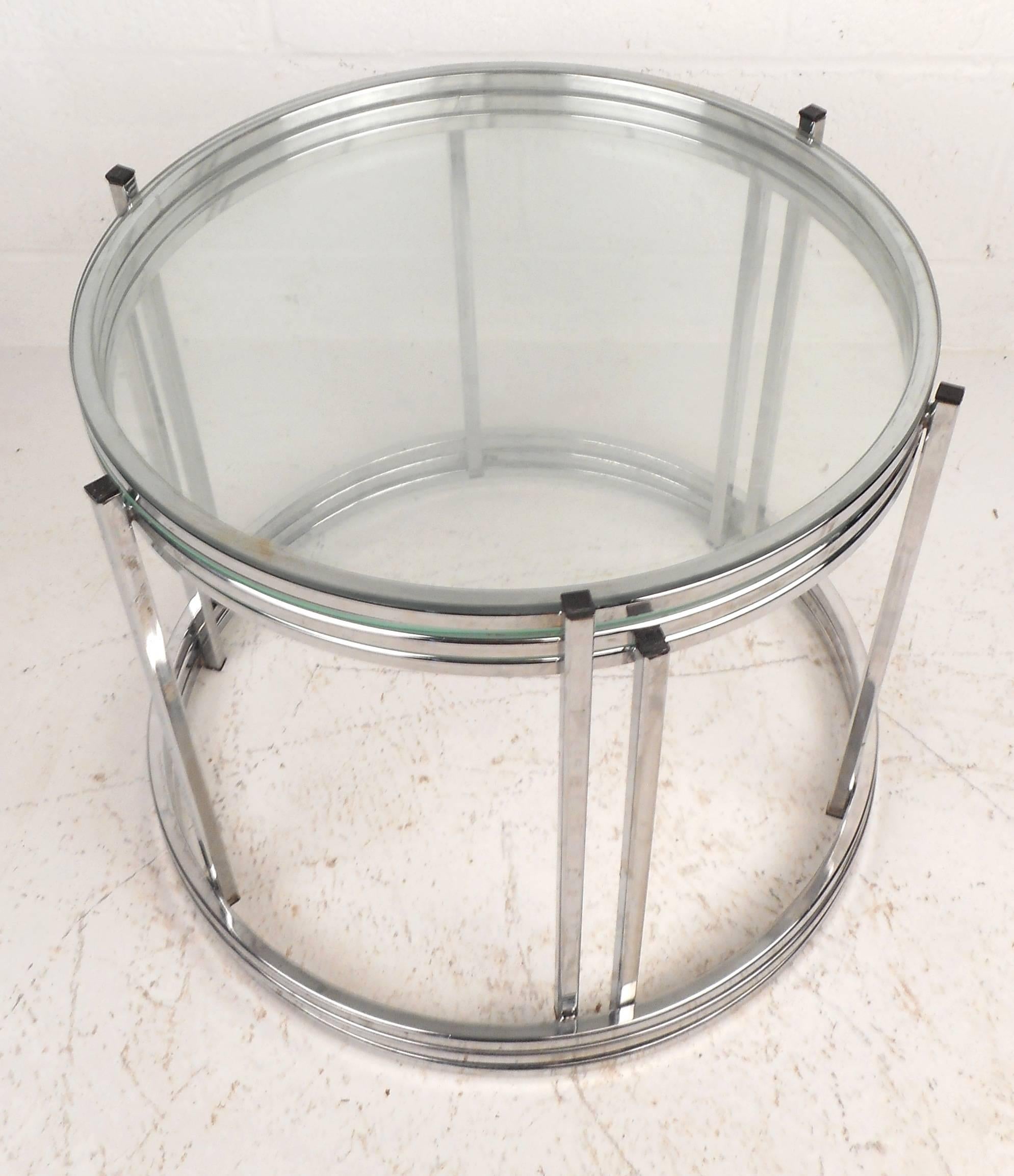 Elegant set of three Mid-Century Modern round stacking or nesting tables with sleek chrome frames and thick green glass tops. The versatile trio fits perfectly on top of each other providing convenience without sacrificing style. Perfect for small