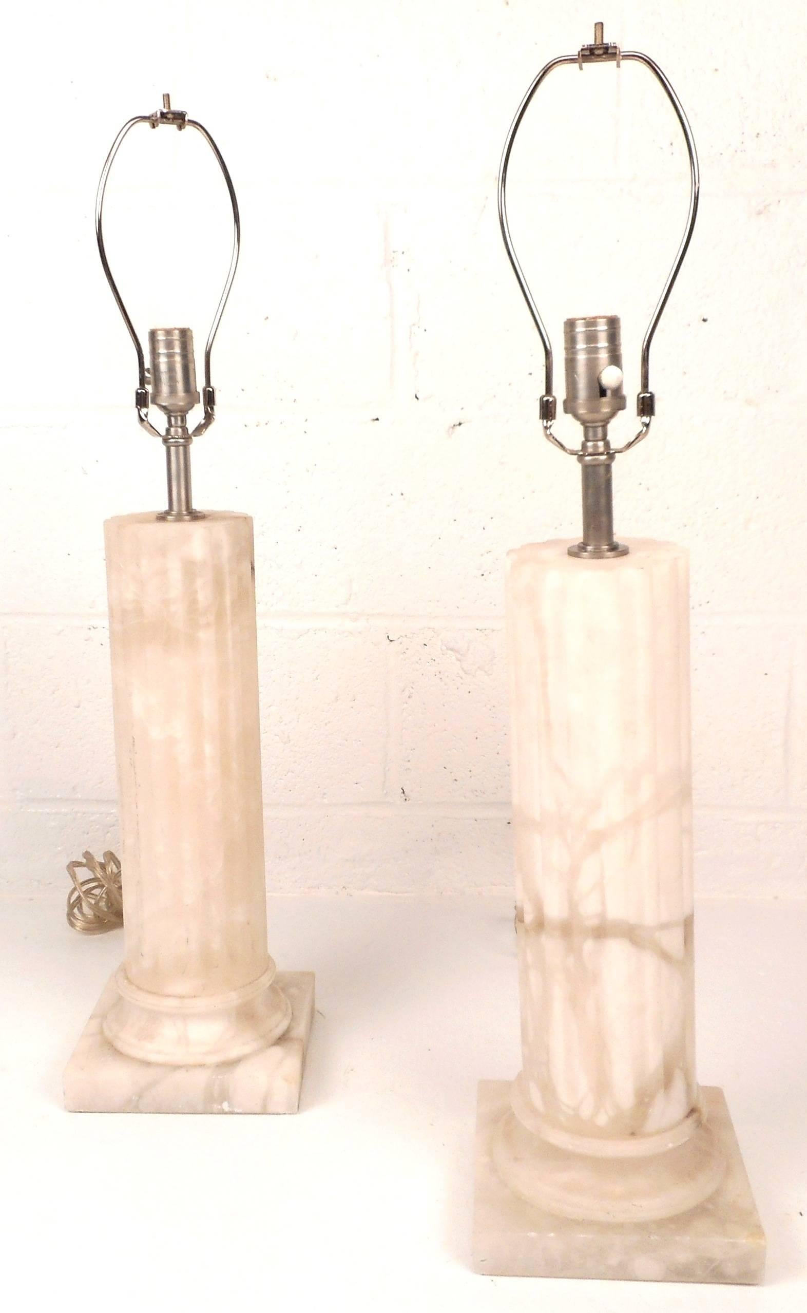 Elegant pair of vintage modern solid marble lamps feature a square base and an etched fluted pedestal design leading up to the light fixture. The unique detailed white marble offers plenty of style in any interior. Please confirm item location (NY