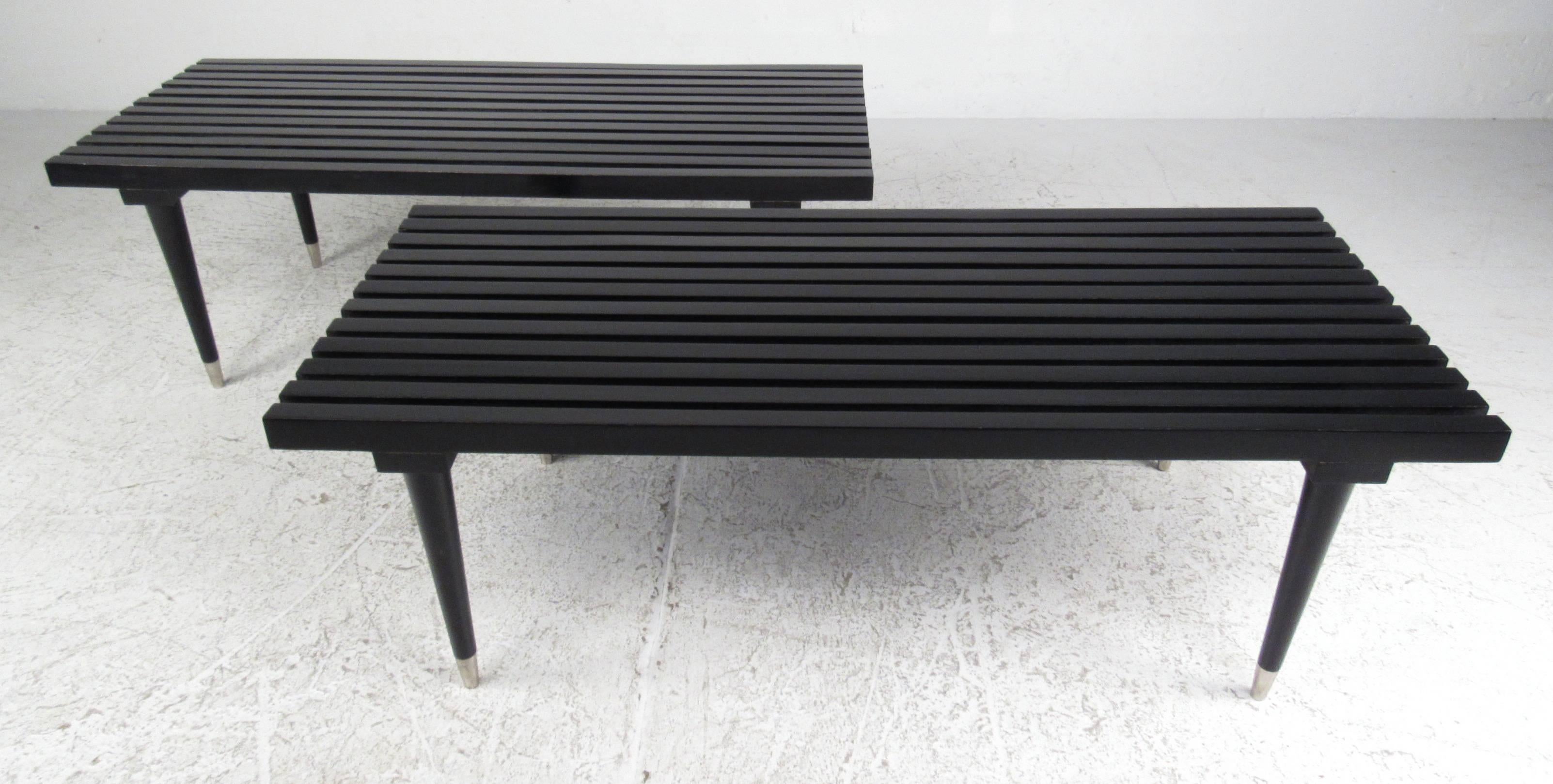 Classic Mid-Century Modern style black ebonized slat benches with tapered legs and silver leg caps. Price is for one bench. Please confirm item location (NY or NJ) with dealer.