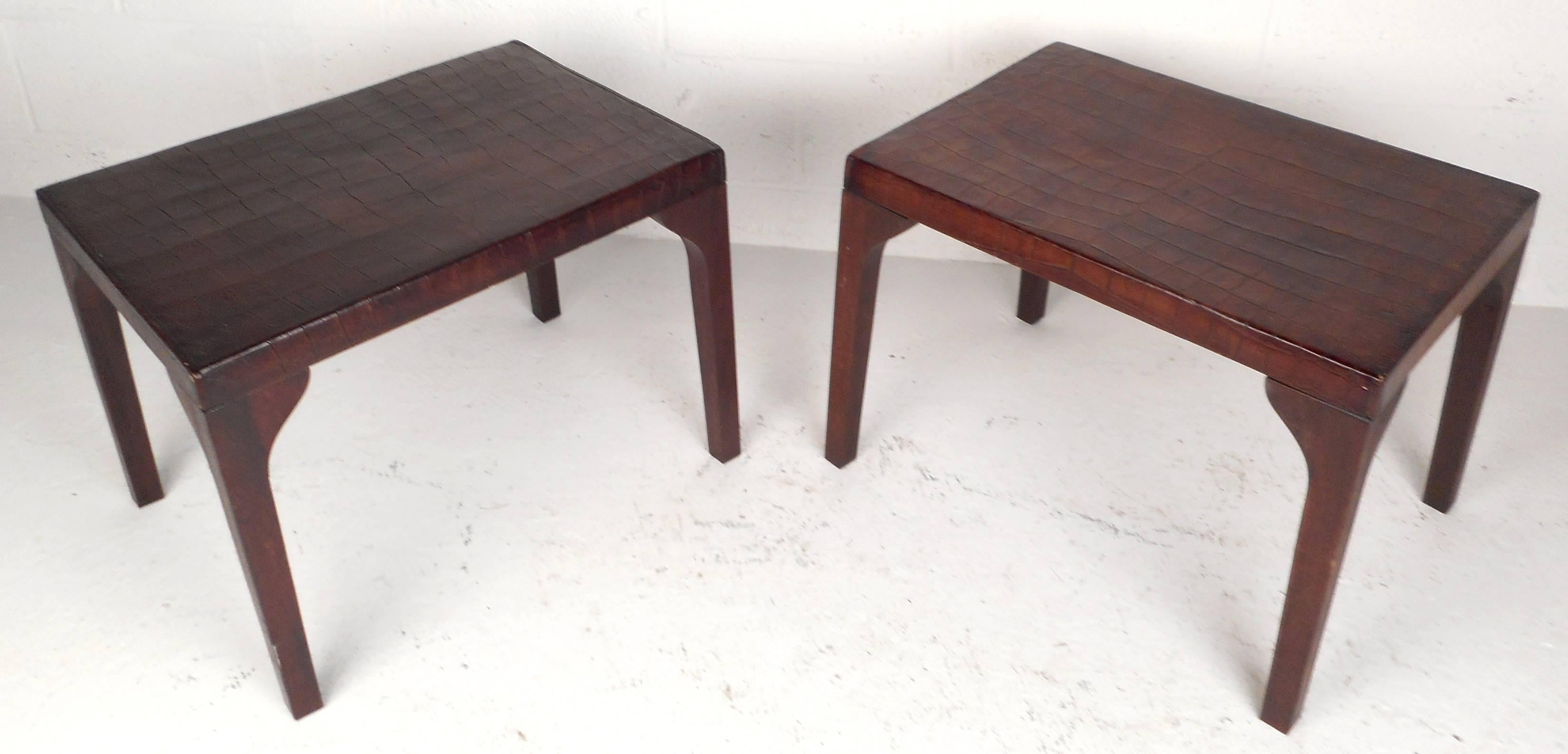 Impressive pair of vintage modern end tables feature embossed brown leather tops with alligator skin detail. The unique sculpted walnut legs offer style and grace in any modern interior. Please confirm item location (NY or NJ).