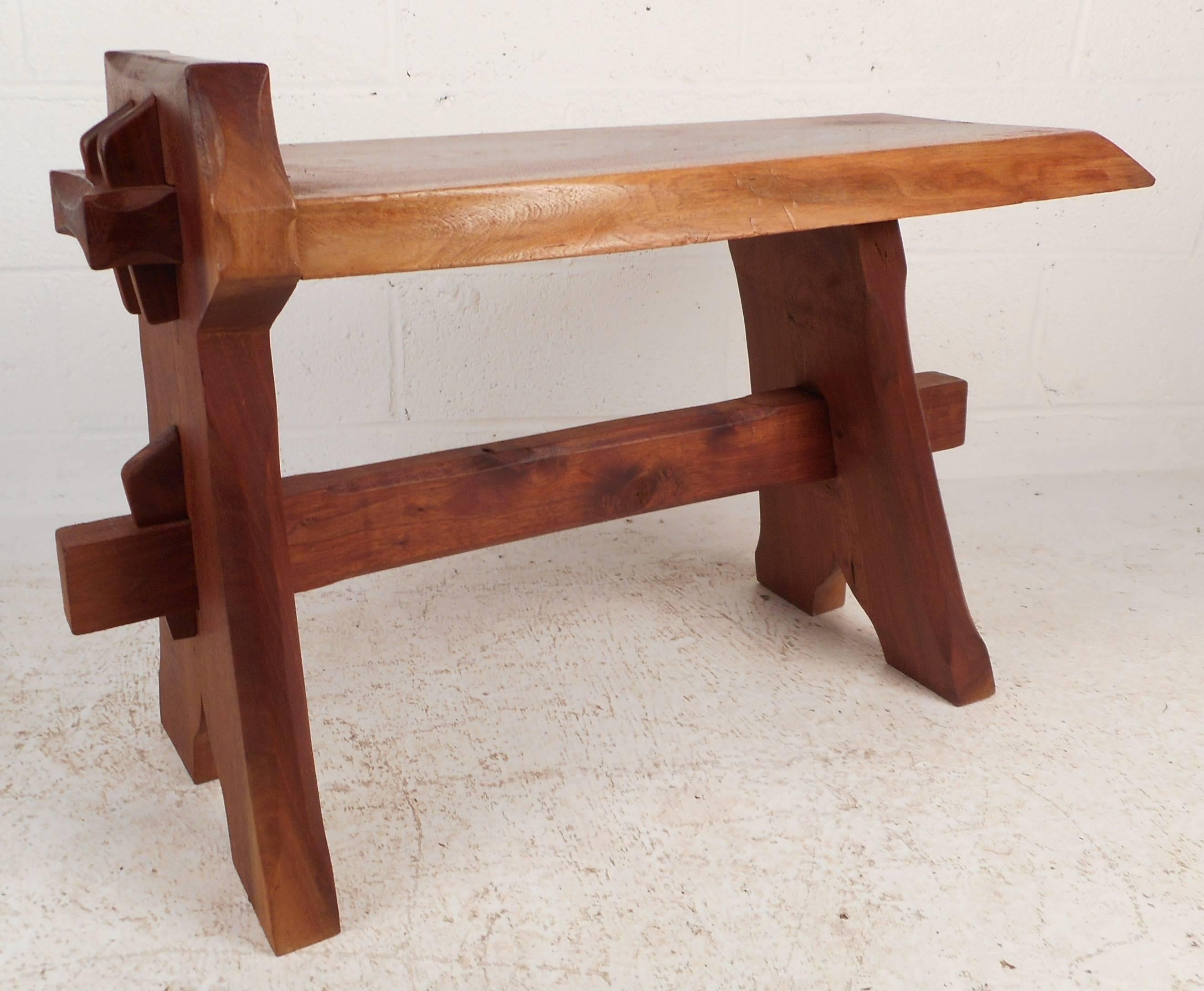 This wonderful vintage modern cobblers bench features a thick tree slab top and sturdy free-form legs. The versatile design can be used as a bench or a table showing quality craftsmanship. Stylish design makes the perfect addition to any modern