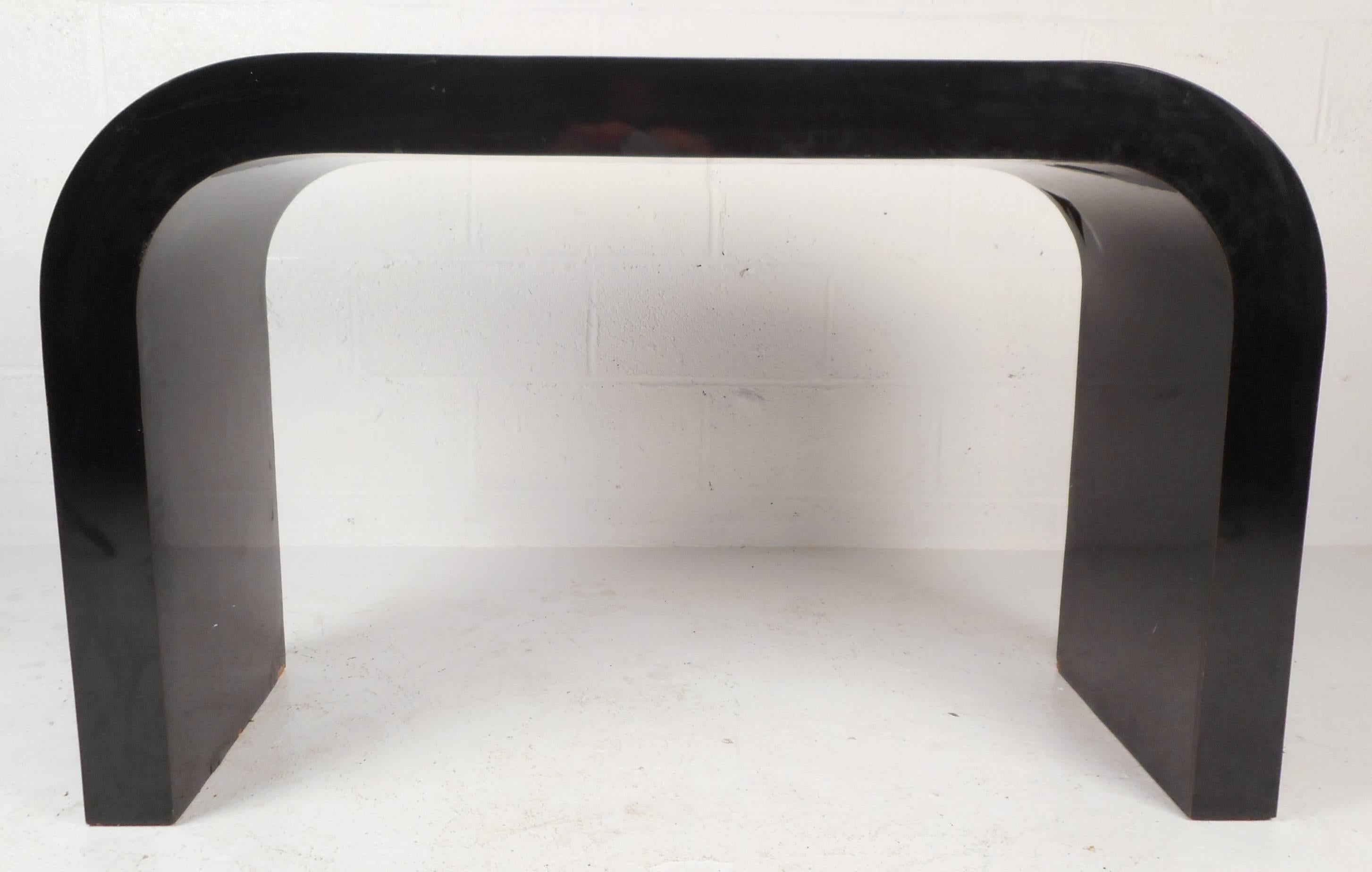 Stunning vintage modern waterfall console table features a sleek black laminate finish and smooth rounded edges. The unique design fits perfectly in any entry way, hallway, or behind the sofa. Please confirm item location (NY or NJ).