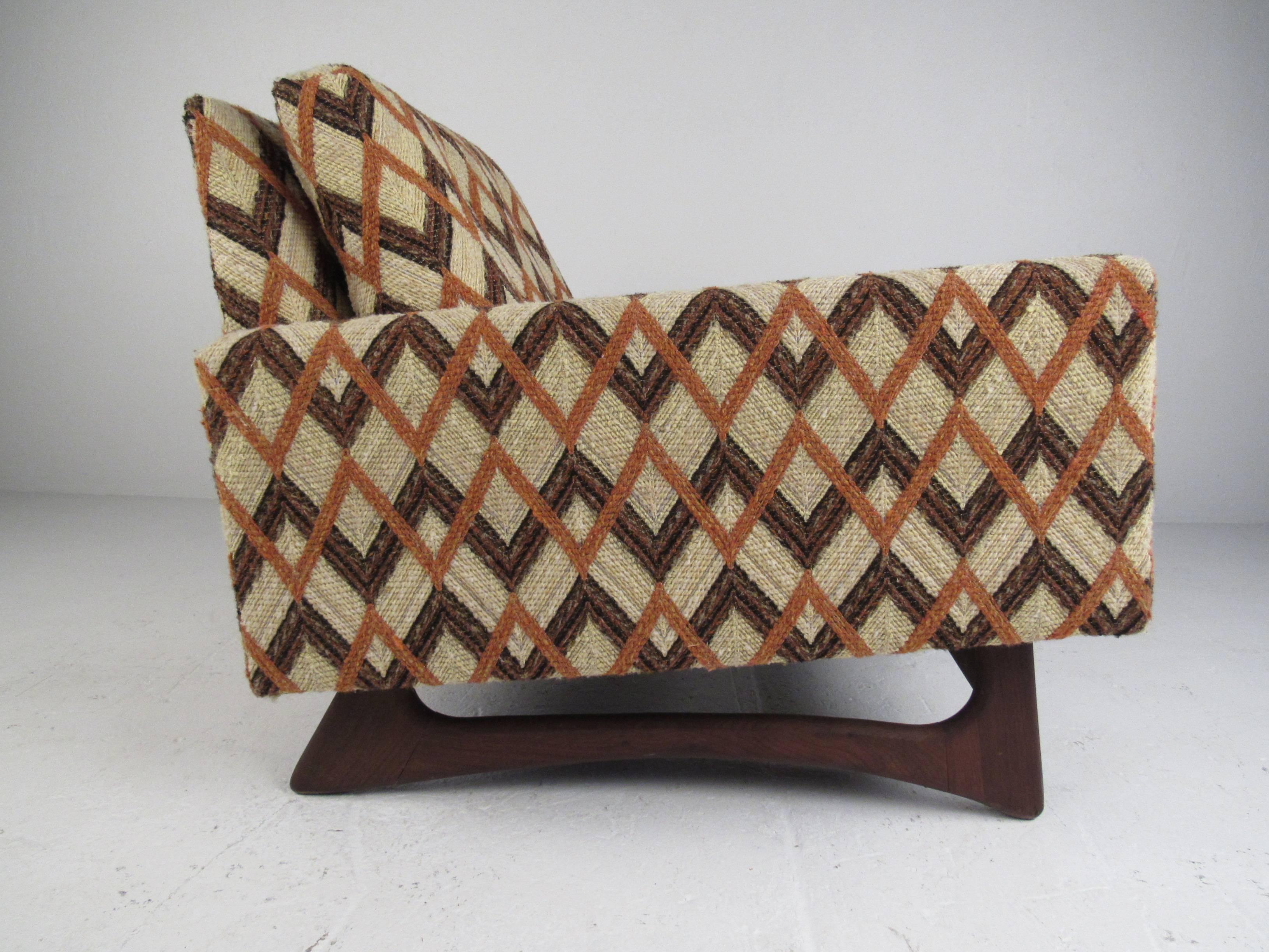 A beautiful vintage modern lounge chair that boasts a sculpted walnut base by Adrian Pearsall for Craft Associates.
