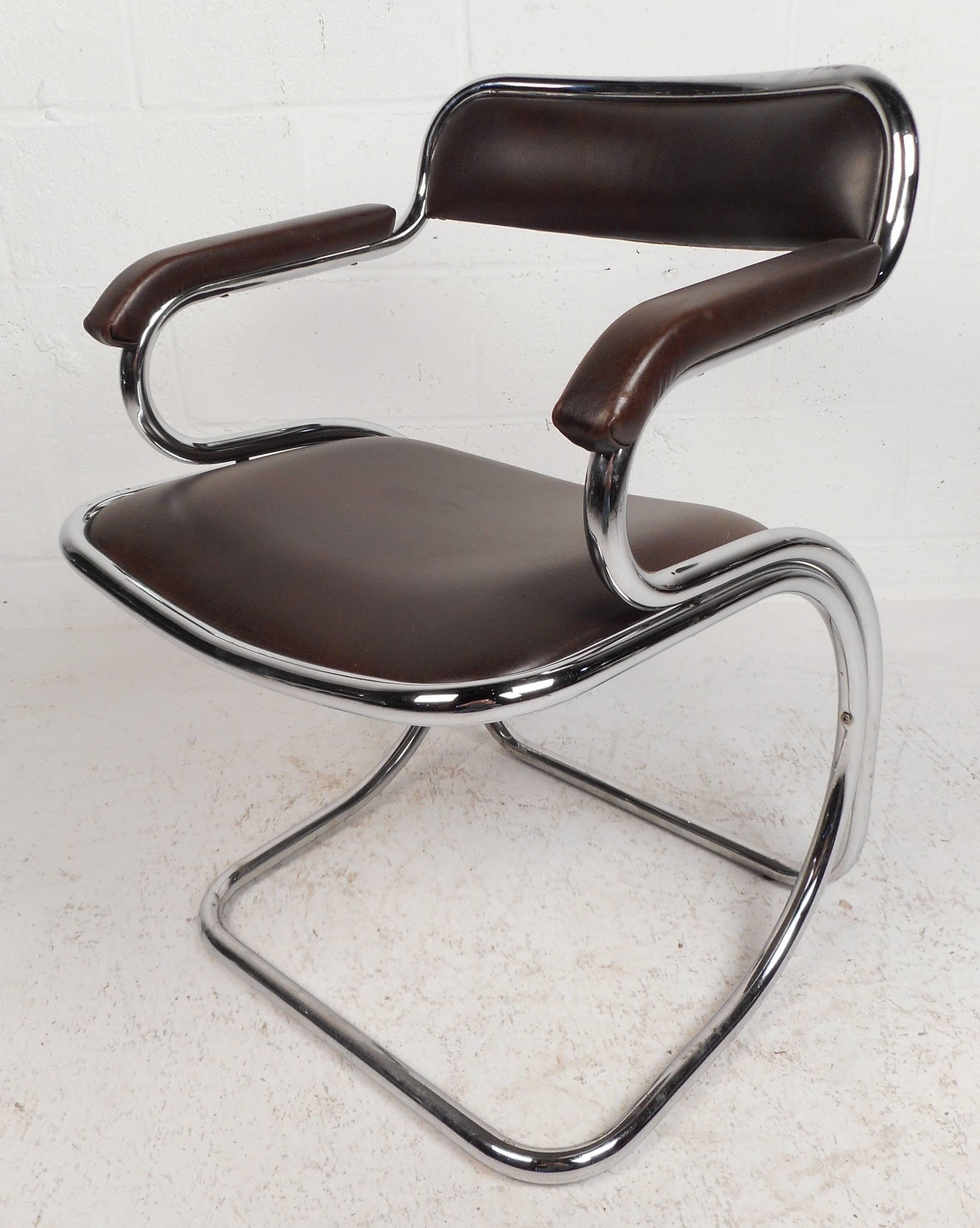 Beautiful set of five vintage modern cantilever dining chairs feature a thick tubular chrome frame and a dark brown vinyl upholstery. The sleek curved frame offers style and sturdiness. The unique upholstered arm rests and backrest ensure comfort in