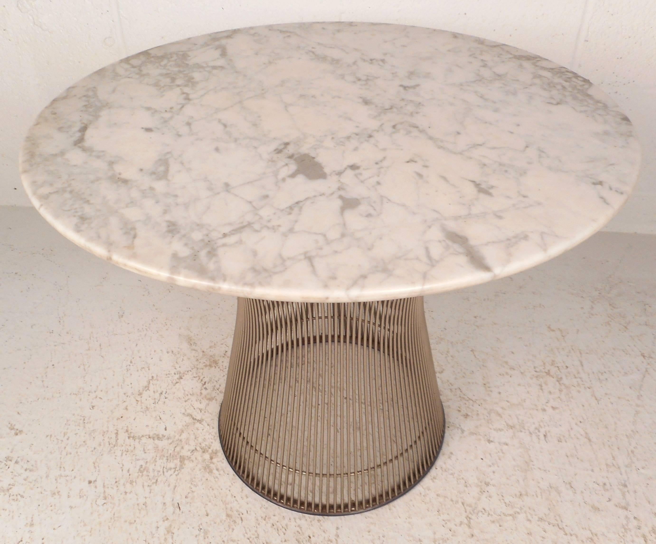 Wonderful vintage modern side table features a thick round marble-top and a sculptural wired chrome base. The sleek design offers sturdiness and style in any modern interior. Perfect addition to any home, business, or office. Please confirm item