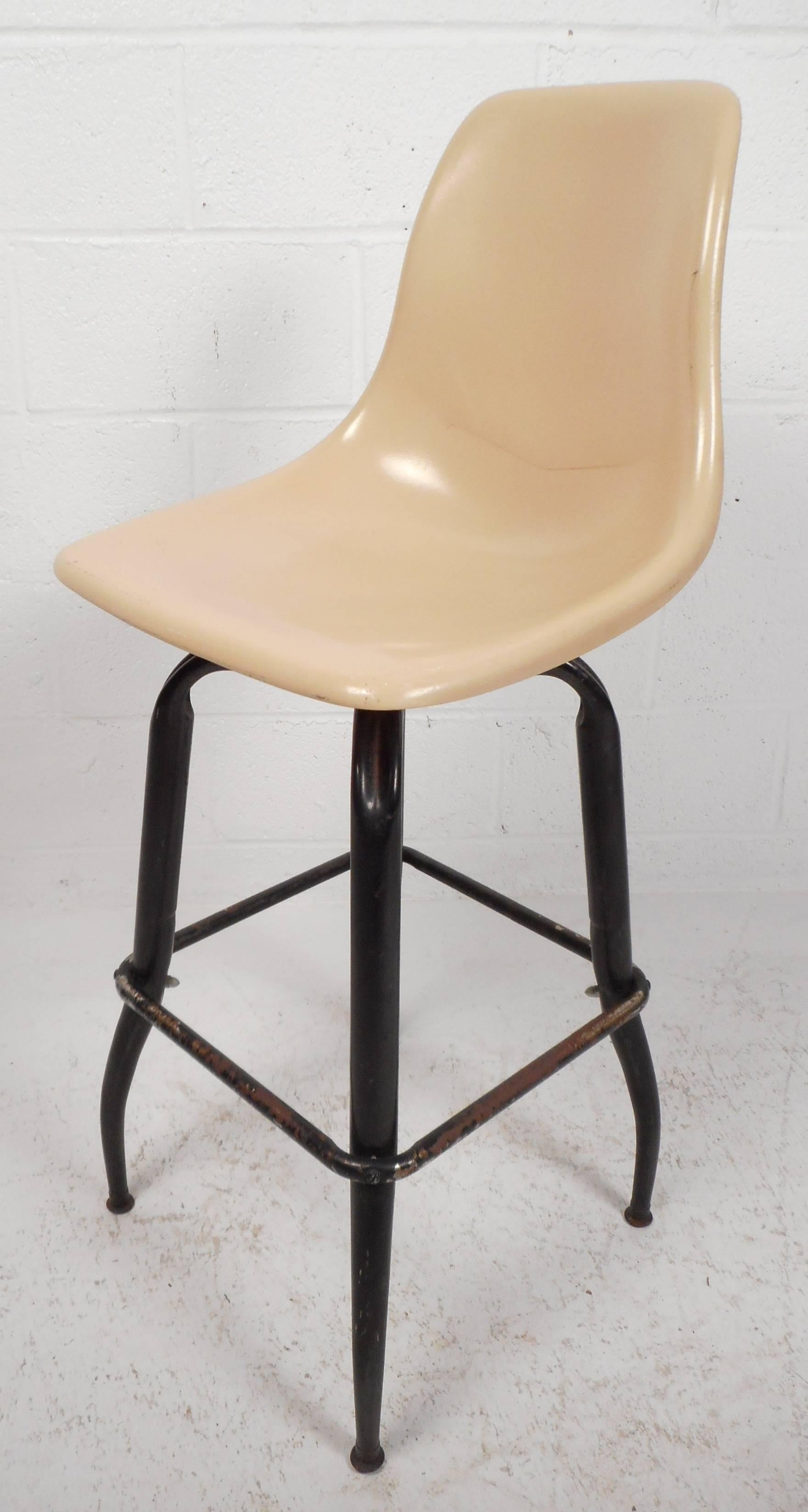 Beautiful set of five vintage modern swivel bar stools with plastic seats sculpted for optimal comfort. Sleek design with sturdy bent rod iron legs showing quality craftsmanship at its best. The wonderful ability to swivel and relax at the same time