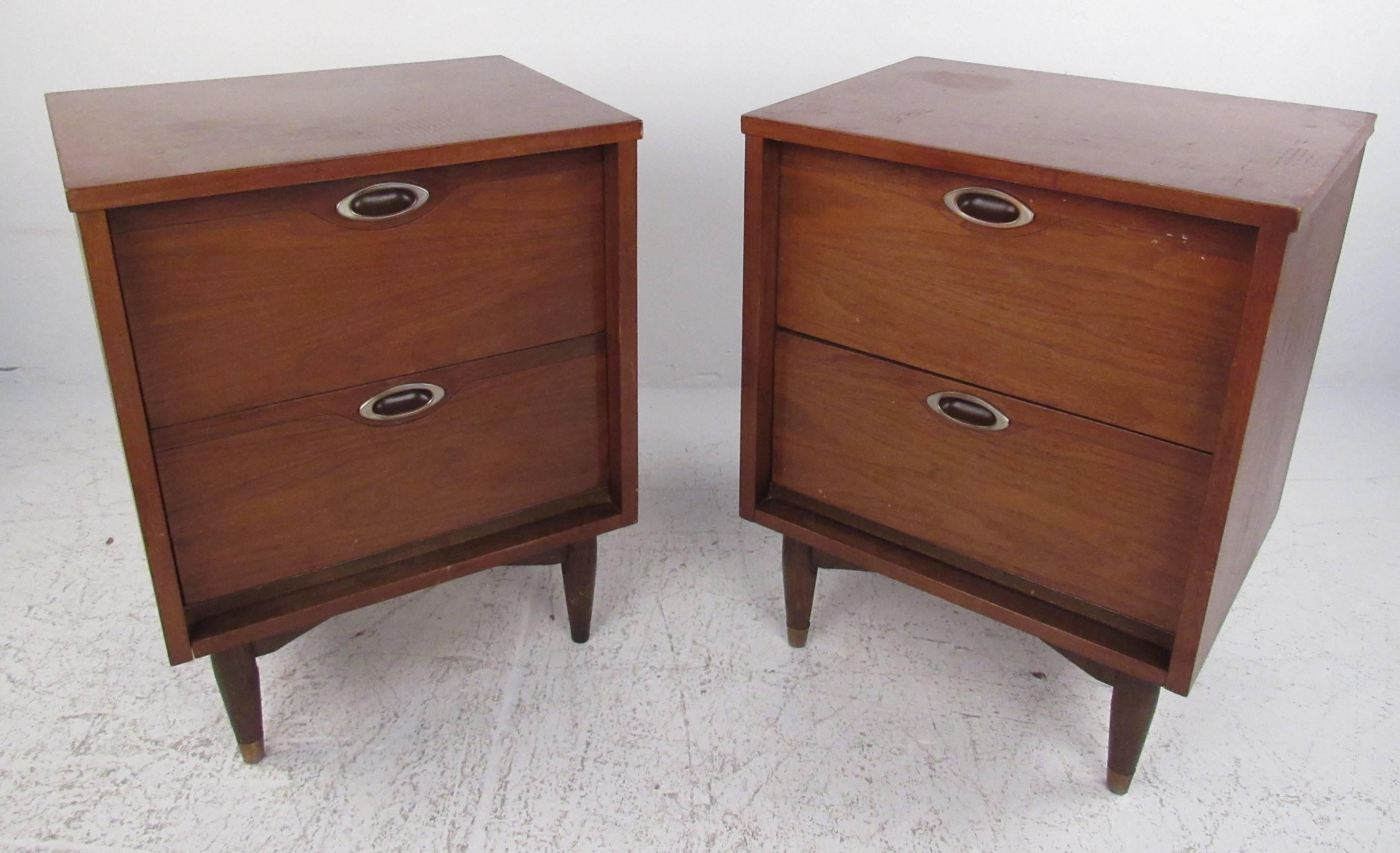 Pair of two-drawer walnut nightstands with recessed pulls and tapered legs from the 