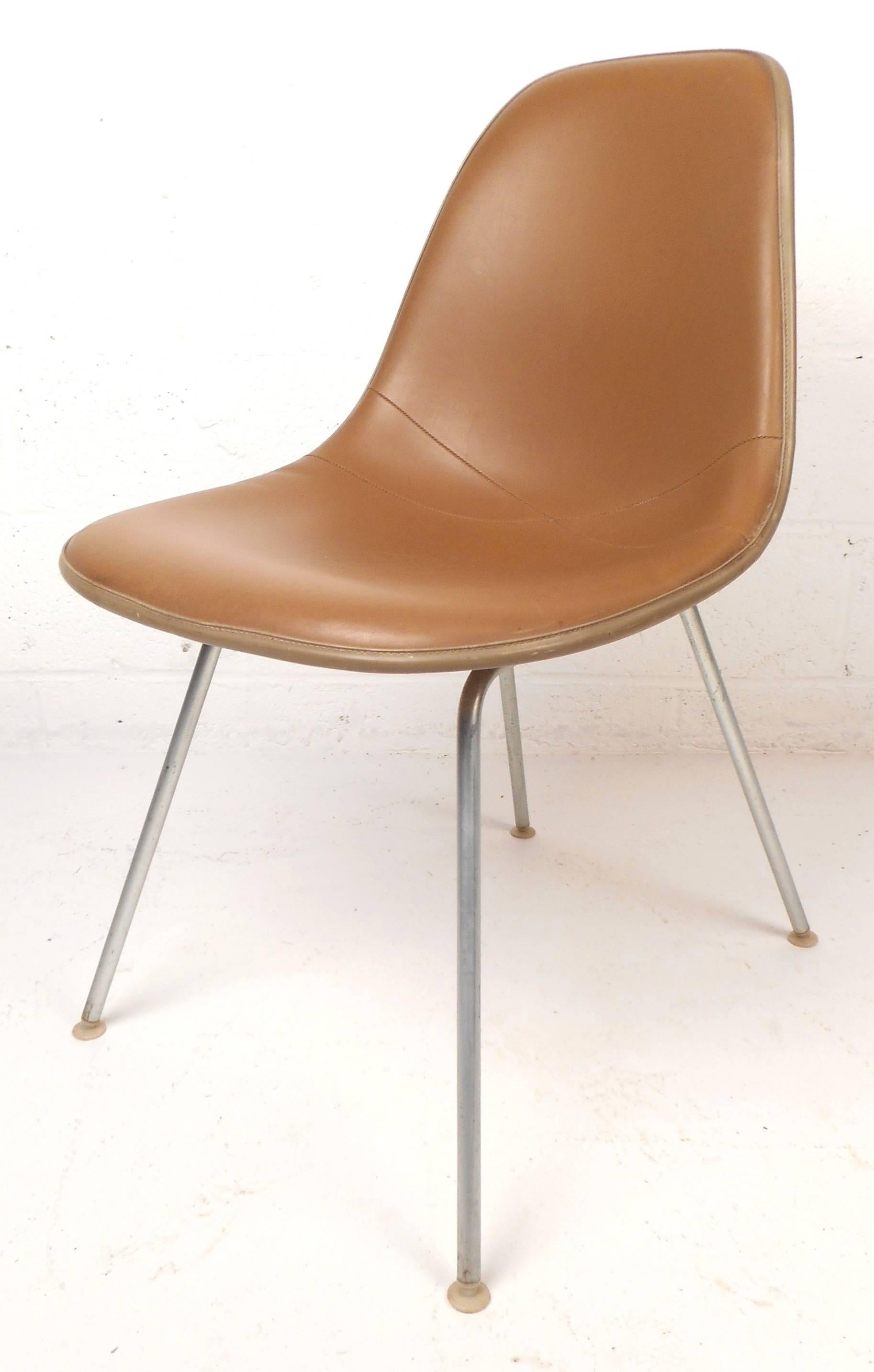This stunning set of five vintage modern chairs feature the iconic shell design with brown chopped strand fiberglass on the back and original seal brown vinyl upholstery. Sleek design with narrow metal H-mount bases ensure sturdiness and style in