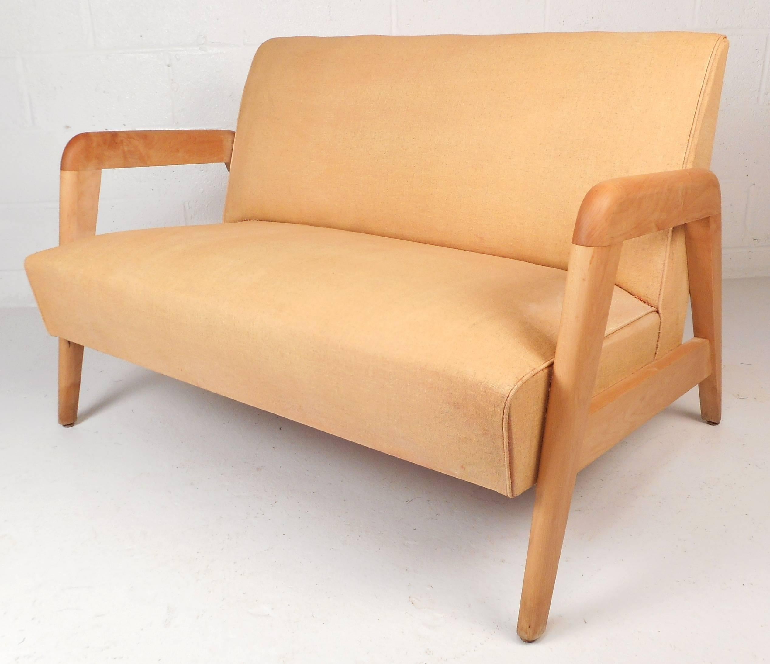 Stunning set of three vintage modern chairs feature two lounge chairs and one settee by Leslie Diamond for Conant Ball. Elegant design with smooth edges on the arm rests and unique angled legs. Solid maple frame and well-padded seats make them the