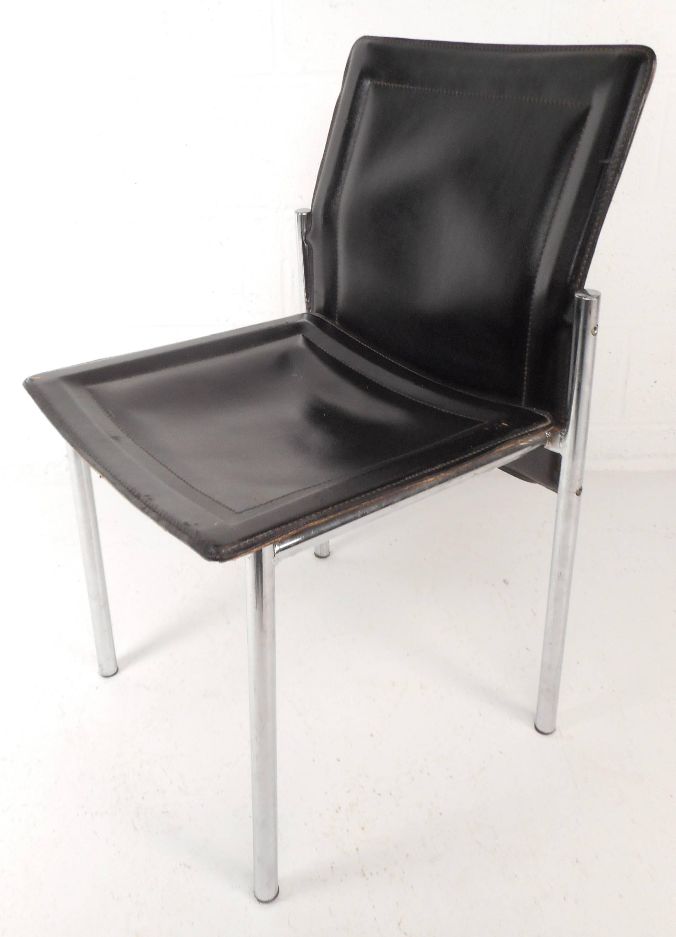 Beautiful set of four vintage modern leather dining chairs feature a unique bent backrest and stitch detail throughout. Elegant design sits on four tubular chrome legs ensuring sturdiness without sacrificing style. Perfect addition to any home,