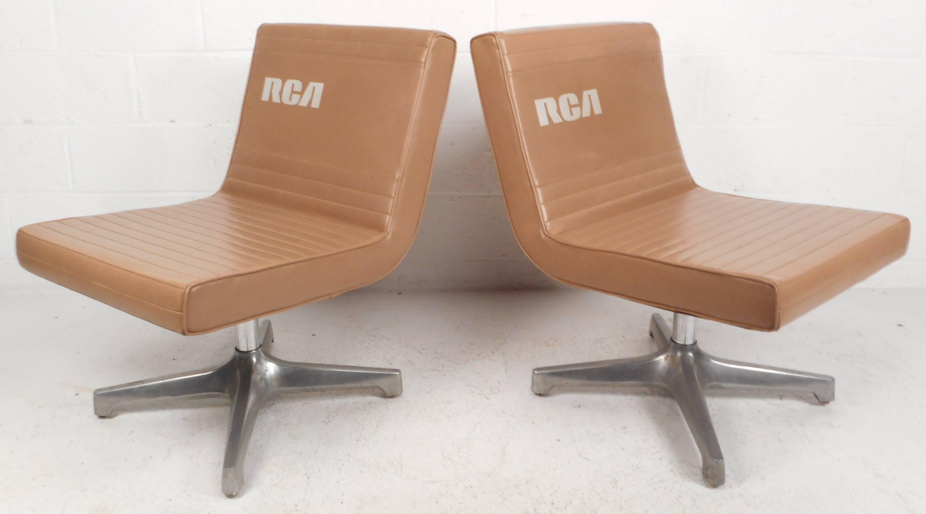 Wonderful pair of vintage modern slipper chairs feature unique seal brown vinyl upholstery and a heavy metal base. Extremely comfortable seating with the letters 