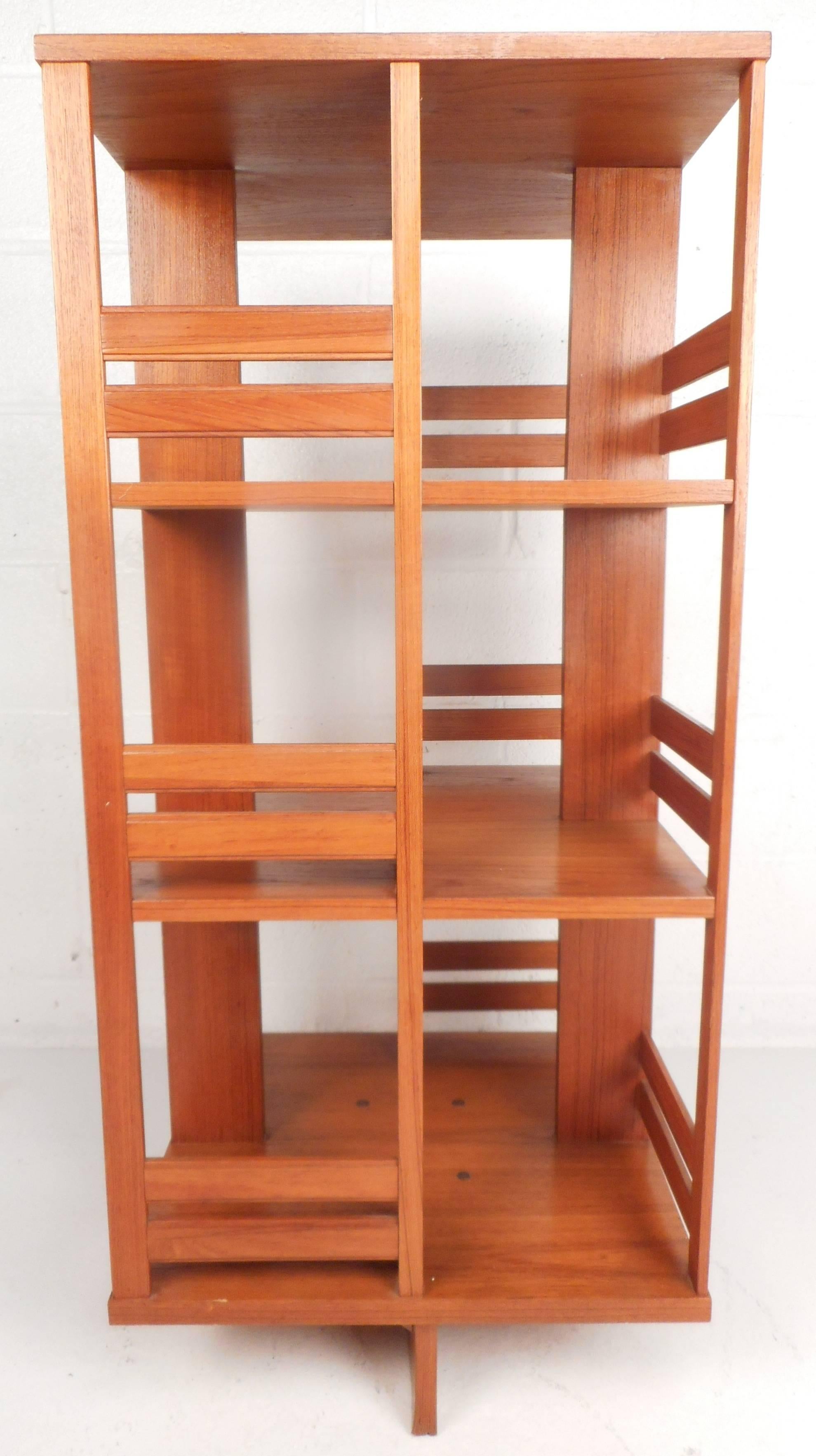 This stunning vintage modern Danish bookcase revolves 360 degrees around ensuring the utmost convenience without sacrificing style. The sleek design has three shelves offering plenty of storage space. The gorgeous teakwood grain is sure to