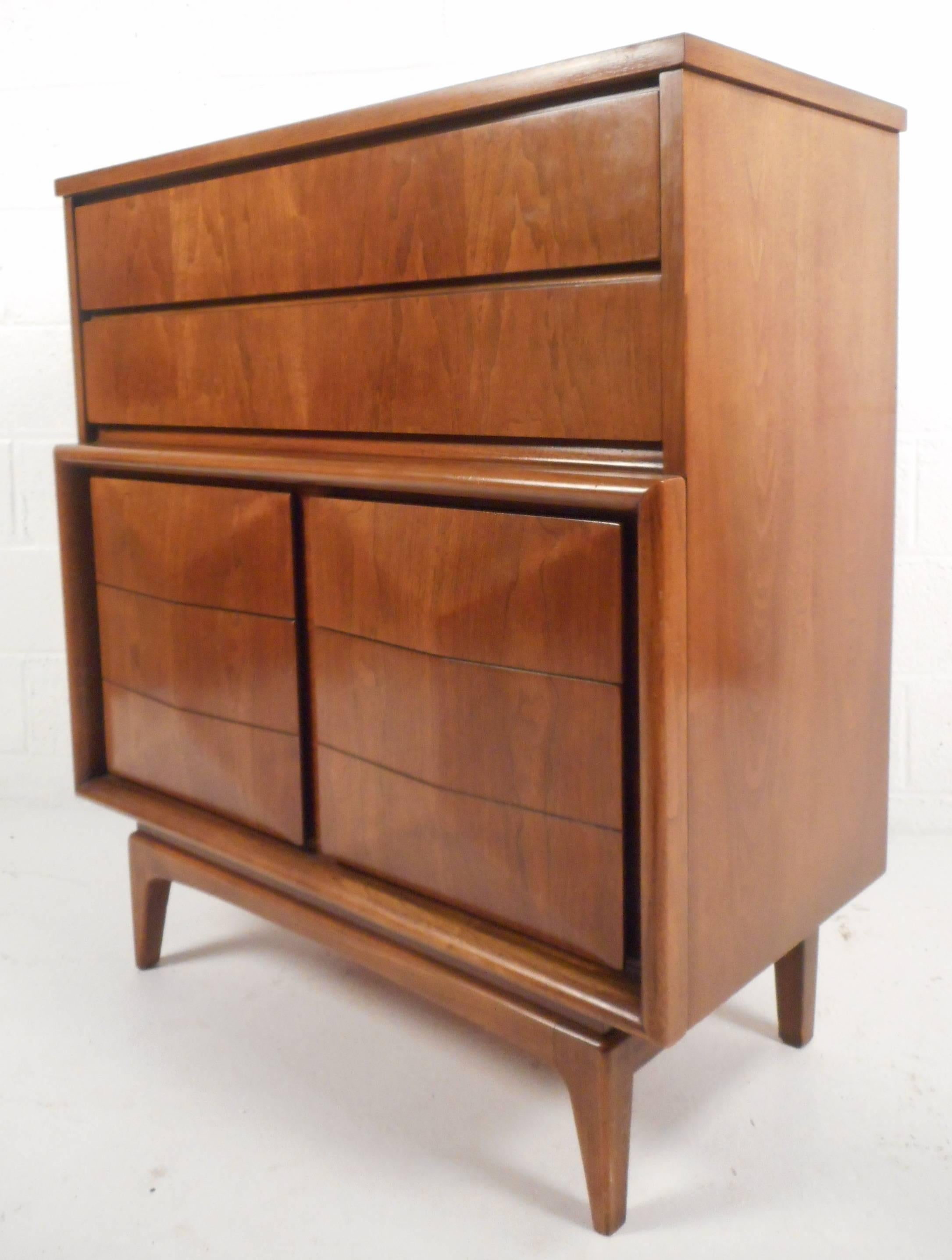 This stunning vintage modern bedroom set includes a nine drawer dresser with a mirror and a matching six drawer high boy. Sleek design with oak trim and a sculpted "diamond" front. This impressive set provides plenty of room for storage