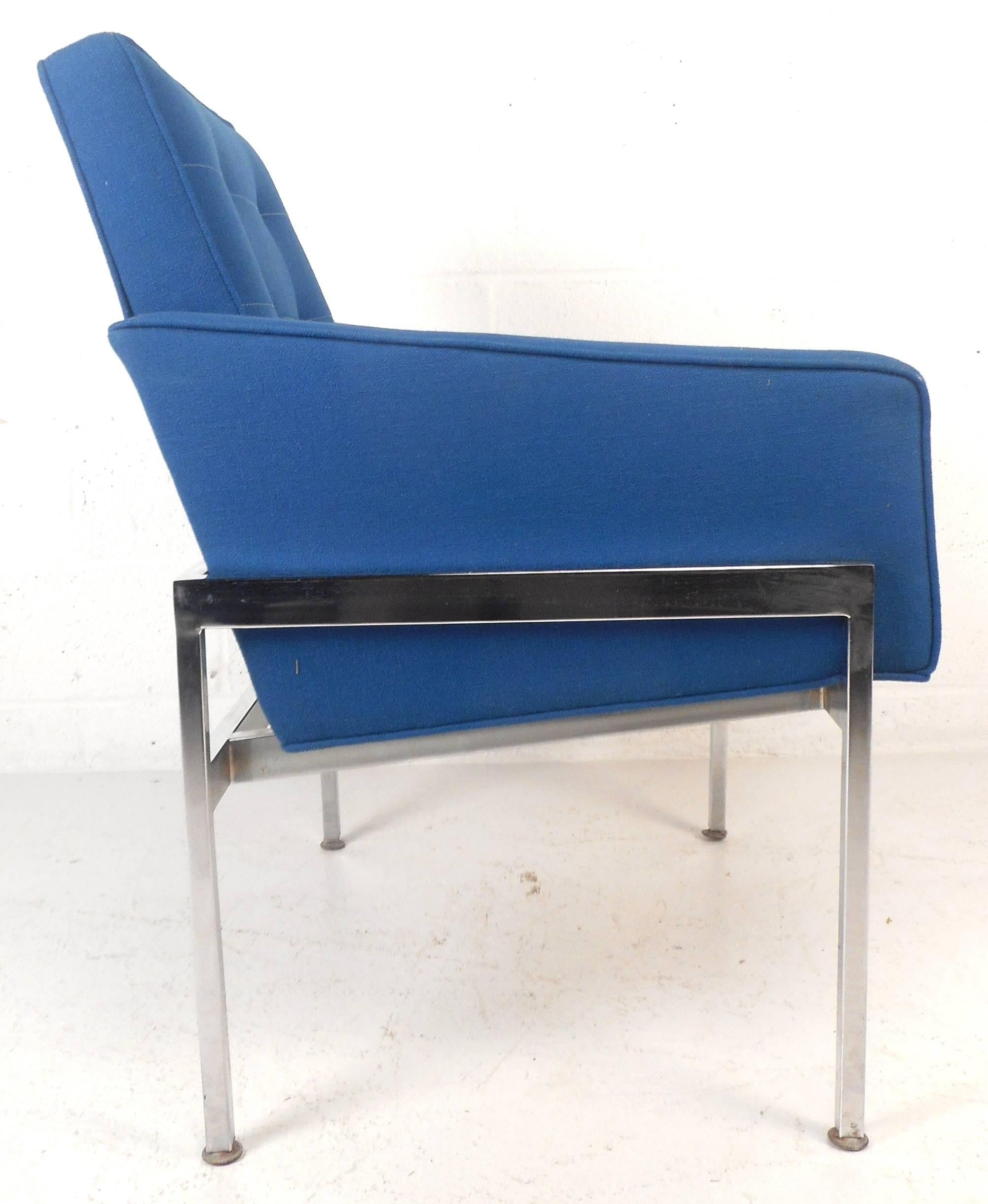 Elegant pair of Mid-Century Modern lounge chairs feature heavy chrome frames with royal blue tufted upholstery. Sleek design with angled backrest and low armrests for added comfort. Soft fabric and thick padded seating make these Mid-Century lounge