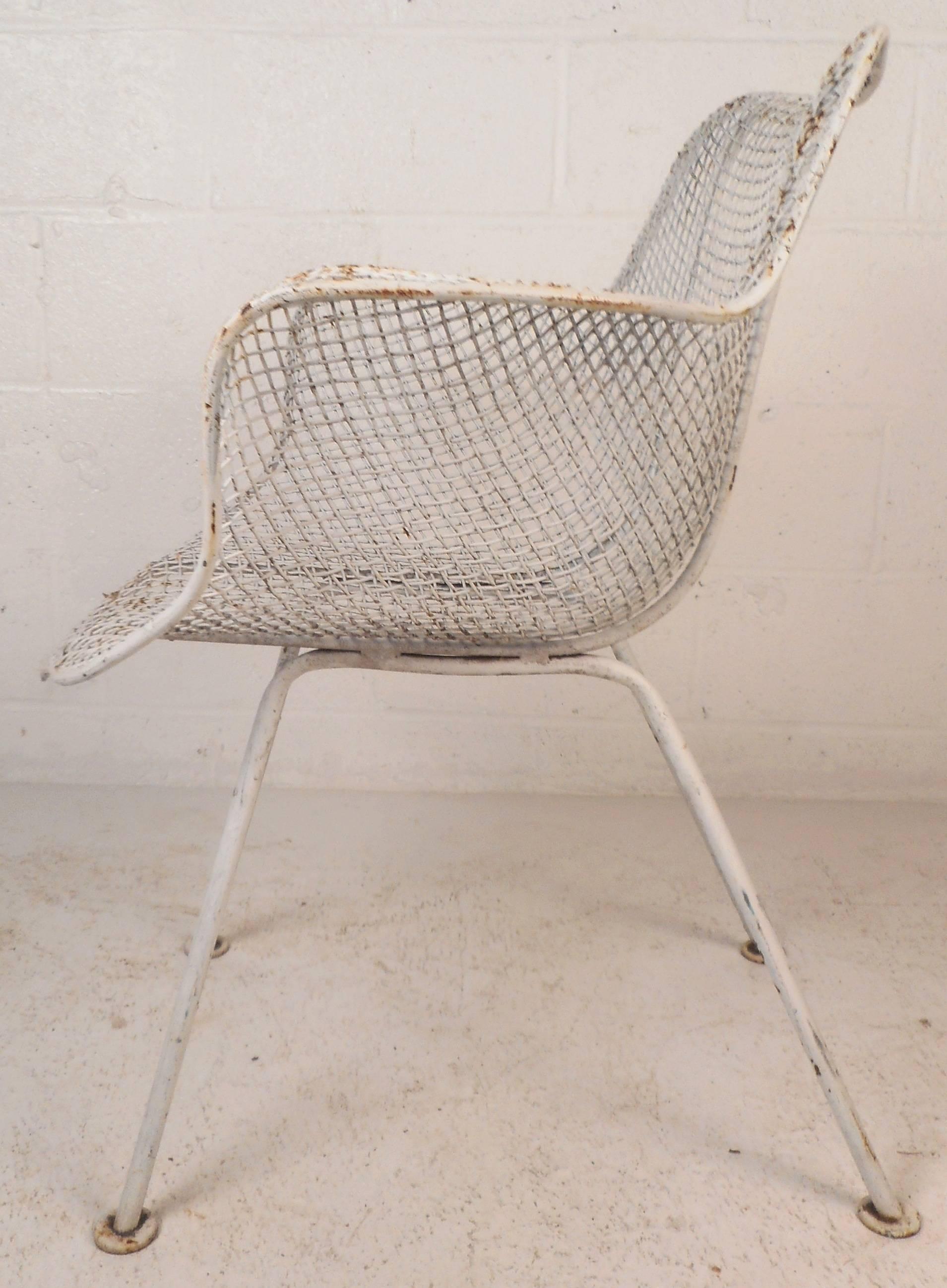 This wonderful vintage modern set of four patio chairs feature sturdy wire mesh frames, angled legs, and unique winged arm rests. The stylish design offers optimal comfort without sacrificing style. This beautiful Mid-Century set make the perfect