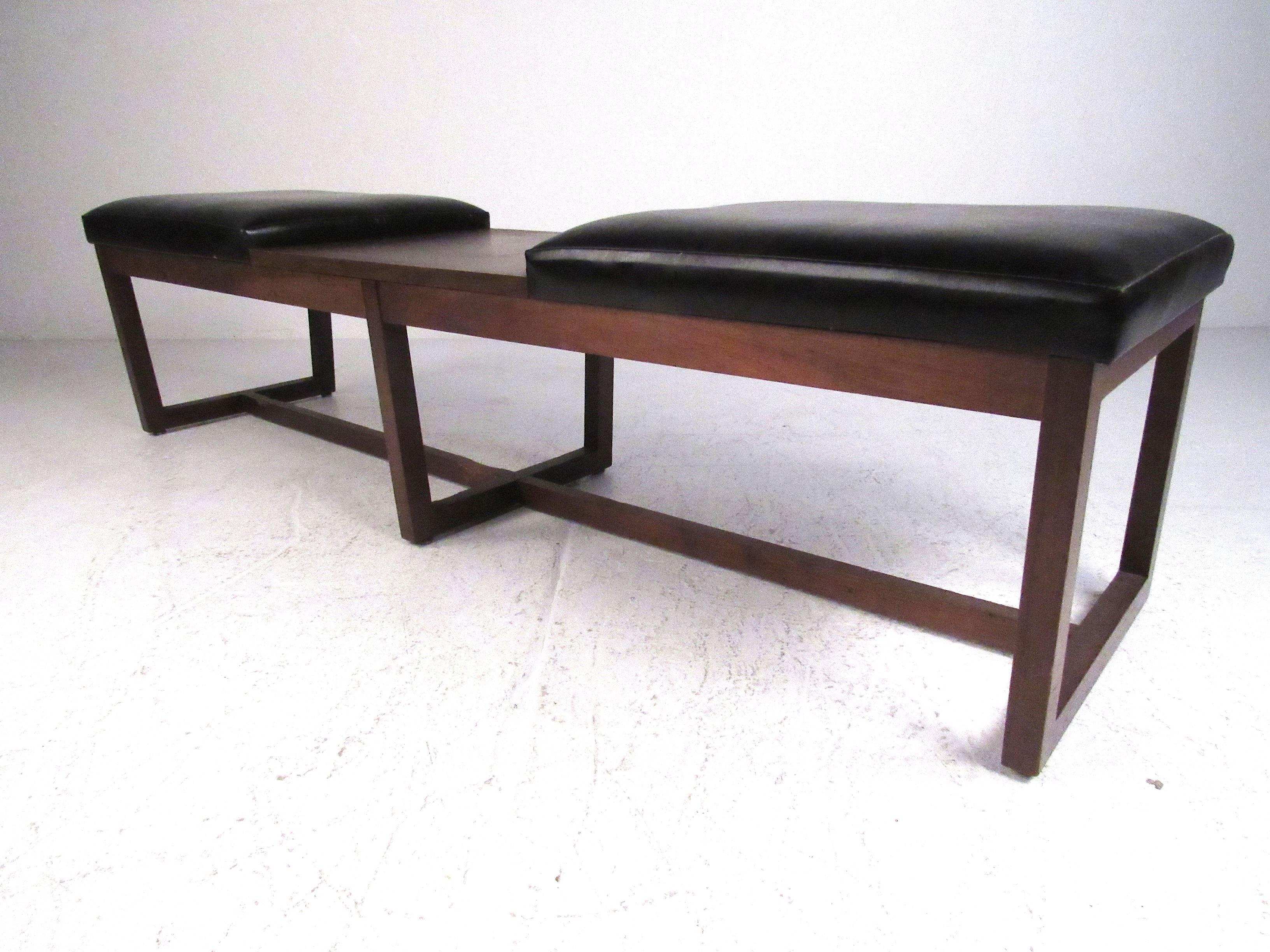 Mid century walnut frame bench seat with black vinyl upholstered cushions and laminate covered center table. Please confirm item location (NY or NJ) with dealer..
 
