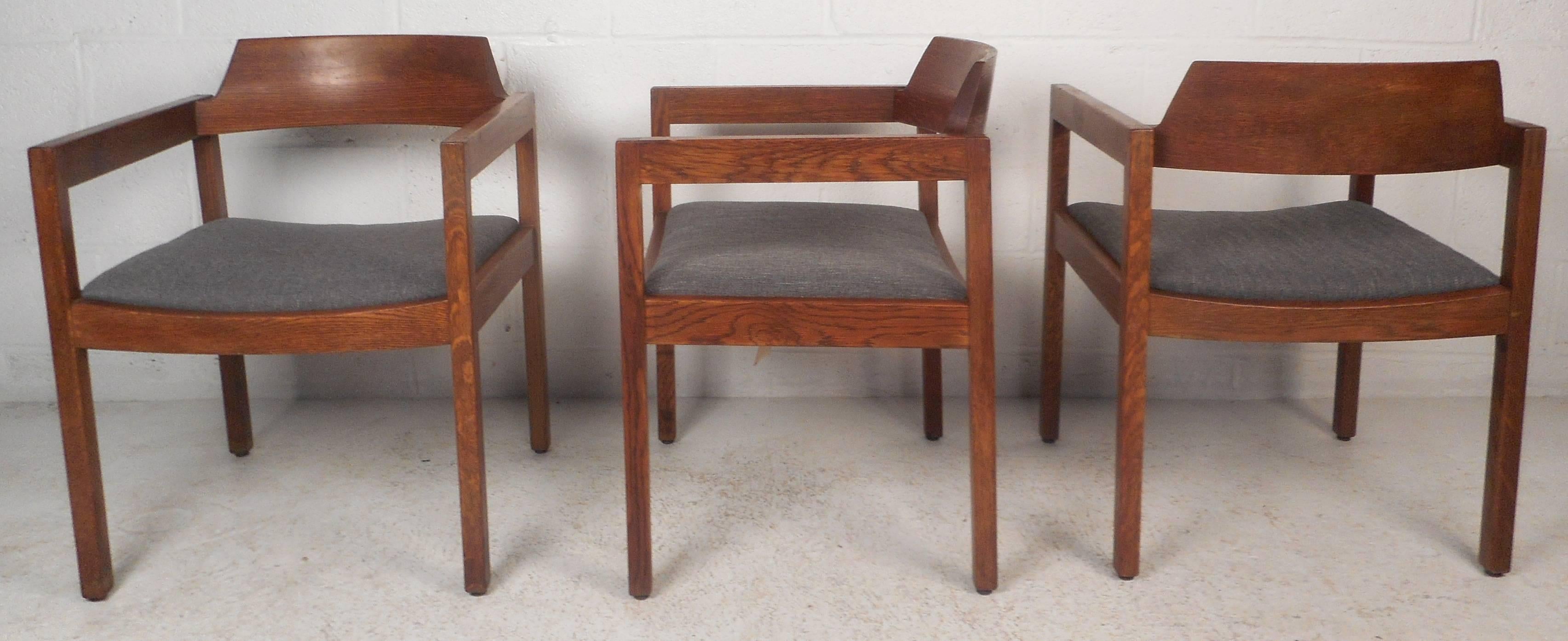 This beautiful set of five vintage modern dining chairs feature a solid walnut frame with arm rests and an upholstered seat. Sleek design with a curved backrest ensures maximum comfort without sacrificing style. Straight line design with dovetail