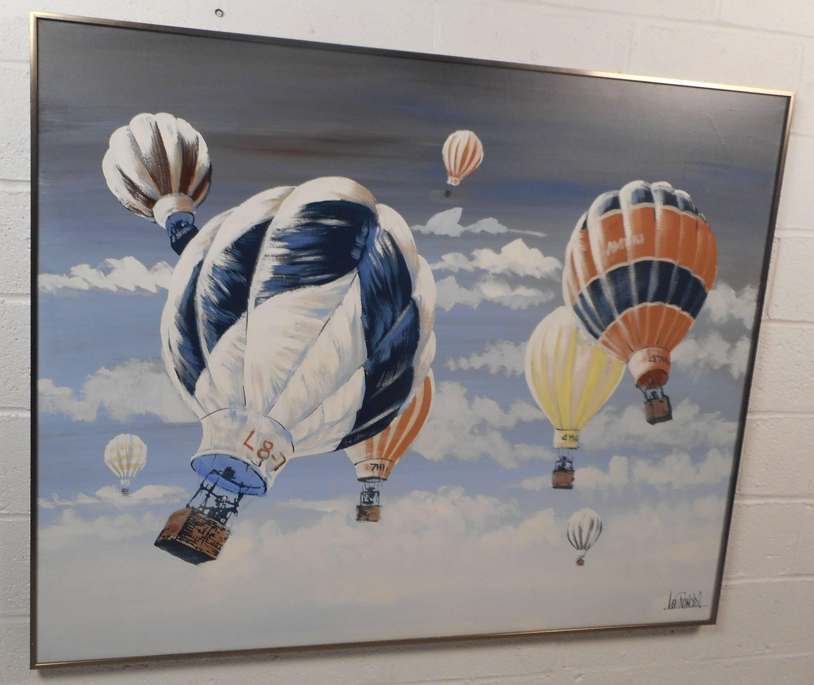 This stunning vintage modern oil painting by manufacturer Lee Reynolds features numerous hot air balloons coasting through the sky with a brass frame. This work of art displays intricate detail with a wide variety of colors. The majestic scene