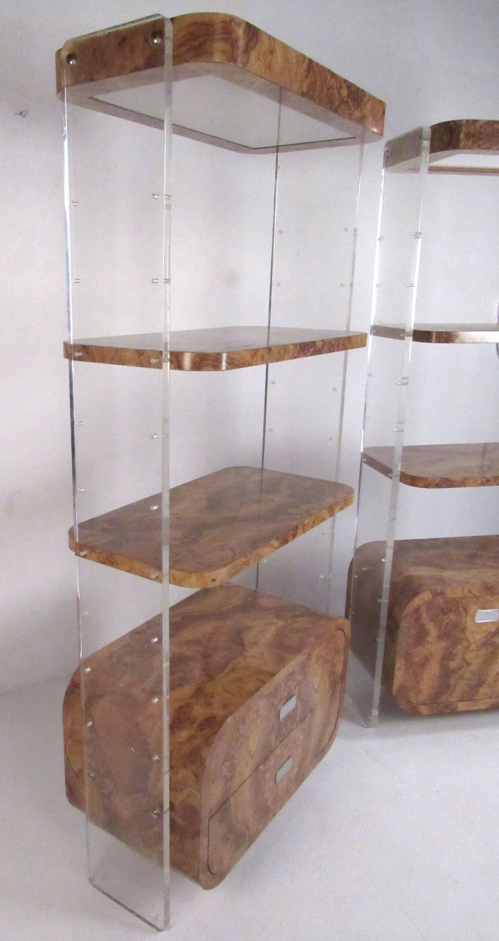 Pair of 1970s Lucite and faux burl wood display shelves with storage units and canopy lights. Each mid-century modern burlwood unit consists of two adjustable shelves, overhead lights and storage cabinet supported by 1' thick Lucite uprights.