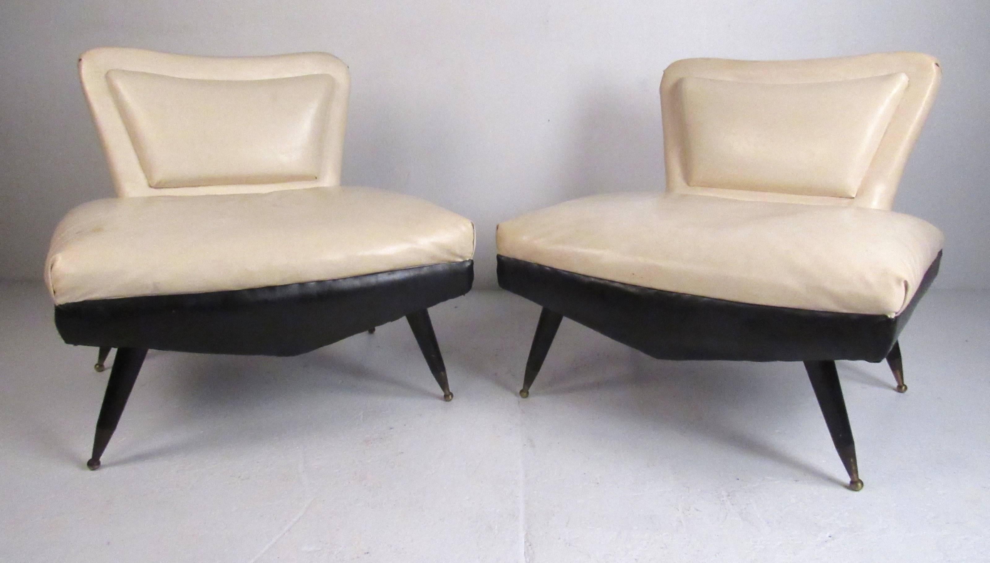 Stylish pair of sculptural Art Deco slipper chairs with tapered legs and brass sabots. Please confirm item location (NY or NJ) with dealer.