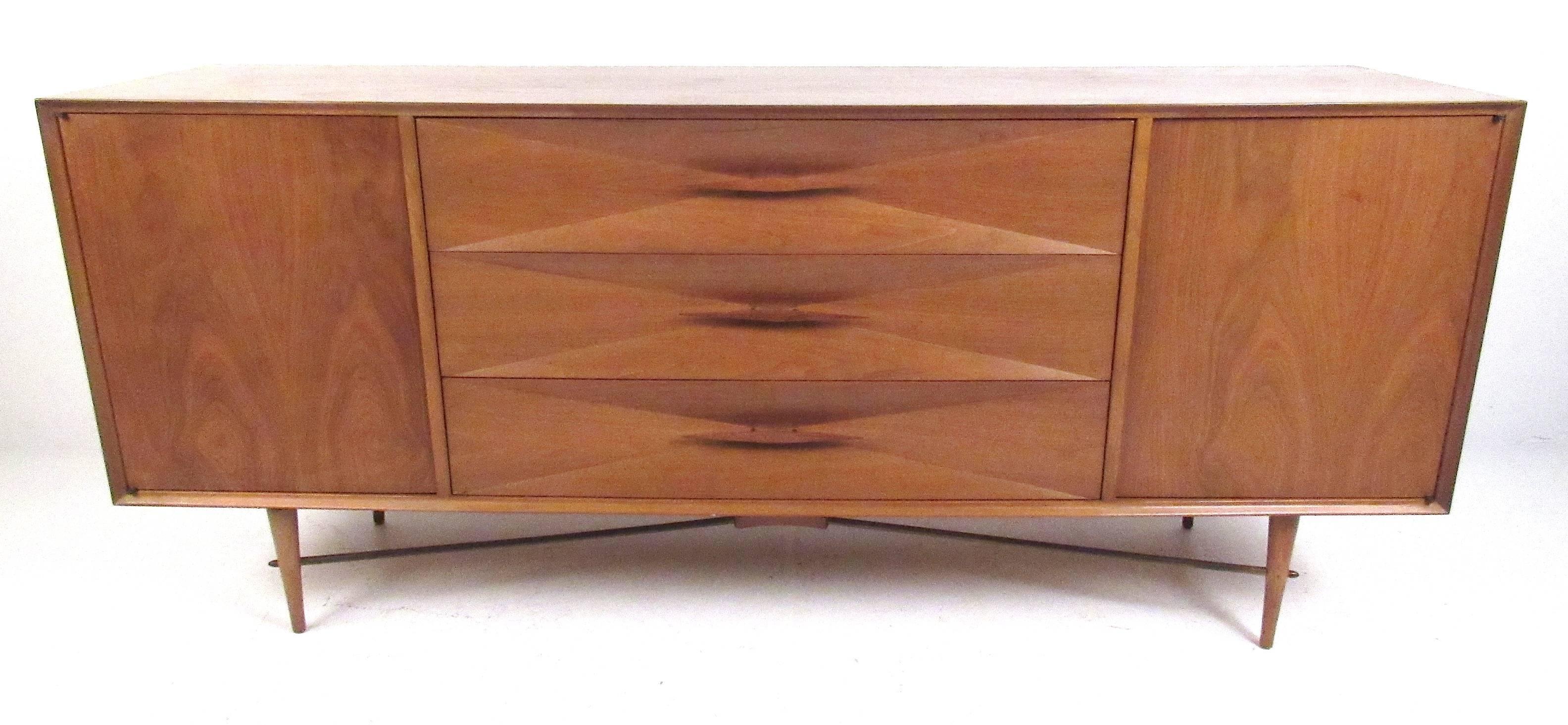 Sculptural nine-drawer diamond front dresser with rare brass stretcher attributed to Albert Parvin, circa 1950s. Please confirm item location (NY or NJ) with dealer.